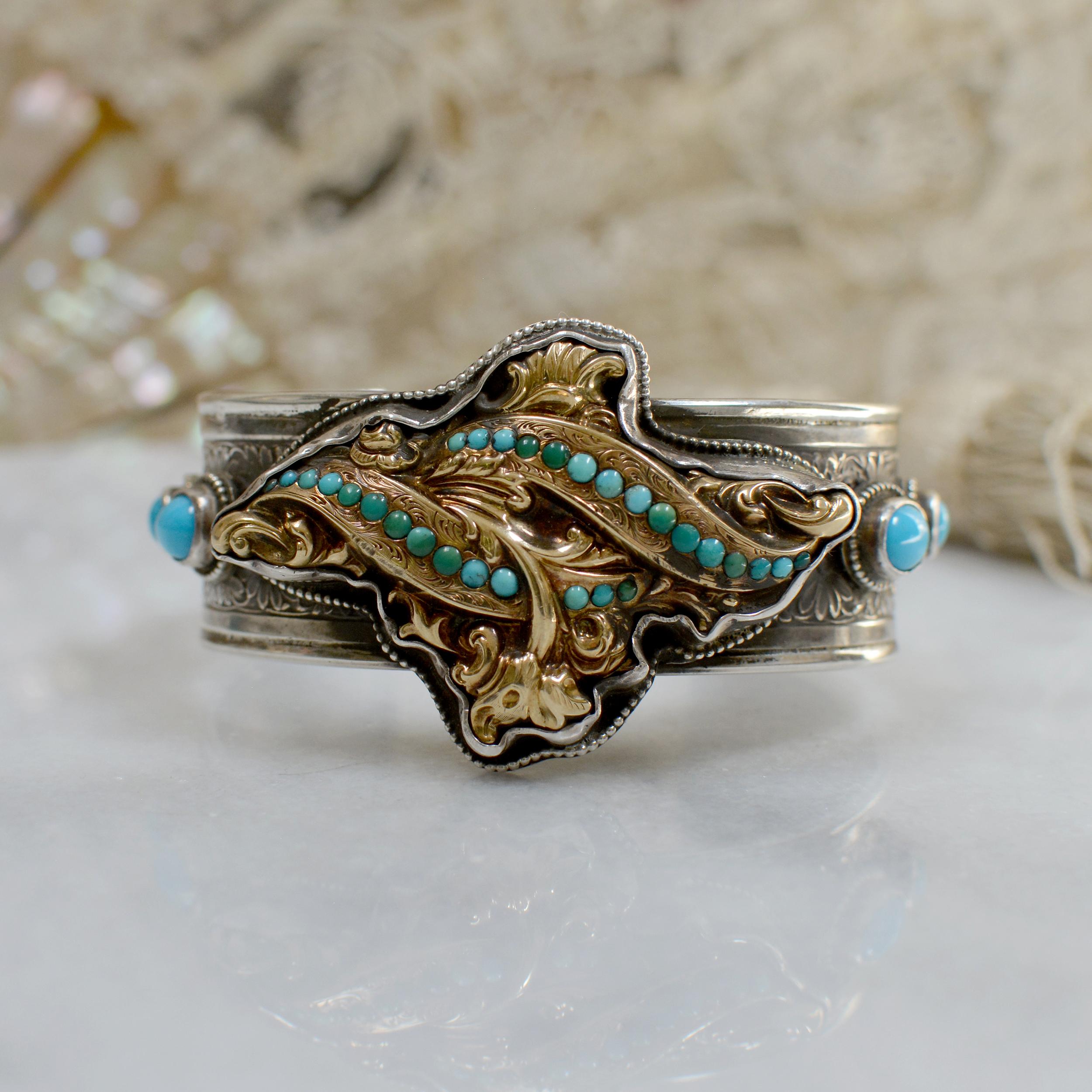 This one of a kind Sterling Silver and Gold cuff bracelet features a Georgian period 14 karat gold brooch delicately framed in beading. On either side are 8 x 6 mm oval and 5 mm Sleeping Beauty turquoise cabochons. An ornate figural floral cuff band