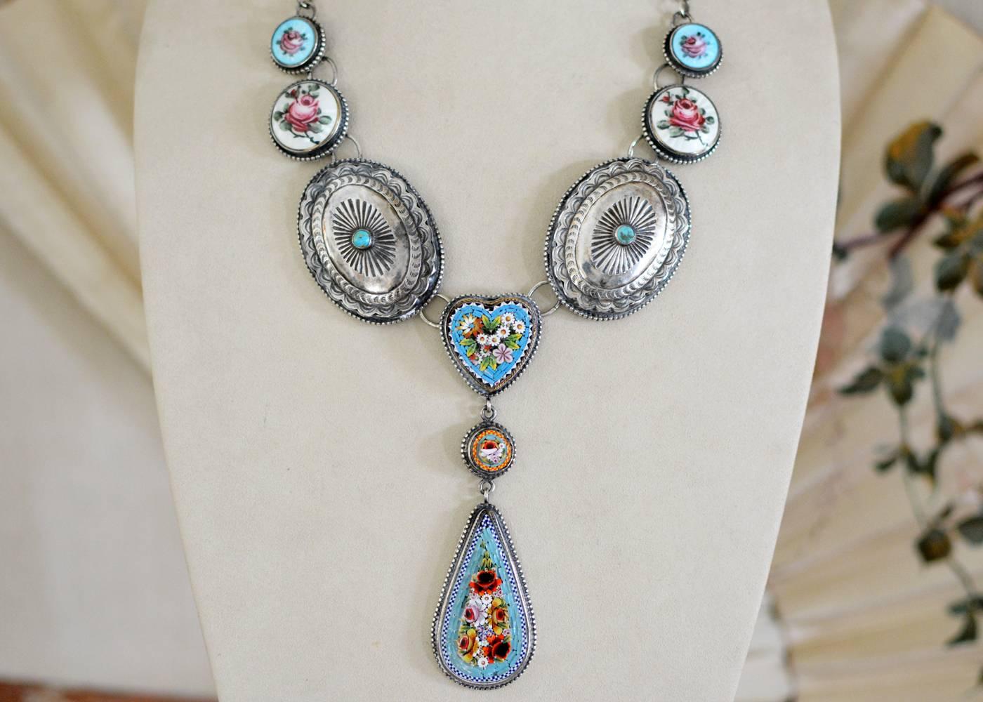This one of a kind drop necklace represents a beautiful marriage of cultures and periods as two bold hand stamped bezel set early Navajo concho's with 6 mm round turquoise cabochon's at their center are joined with a delicate antique Venetian Micro