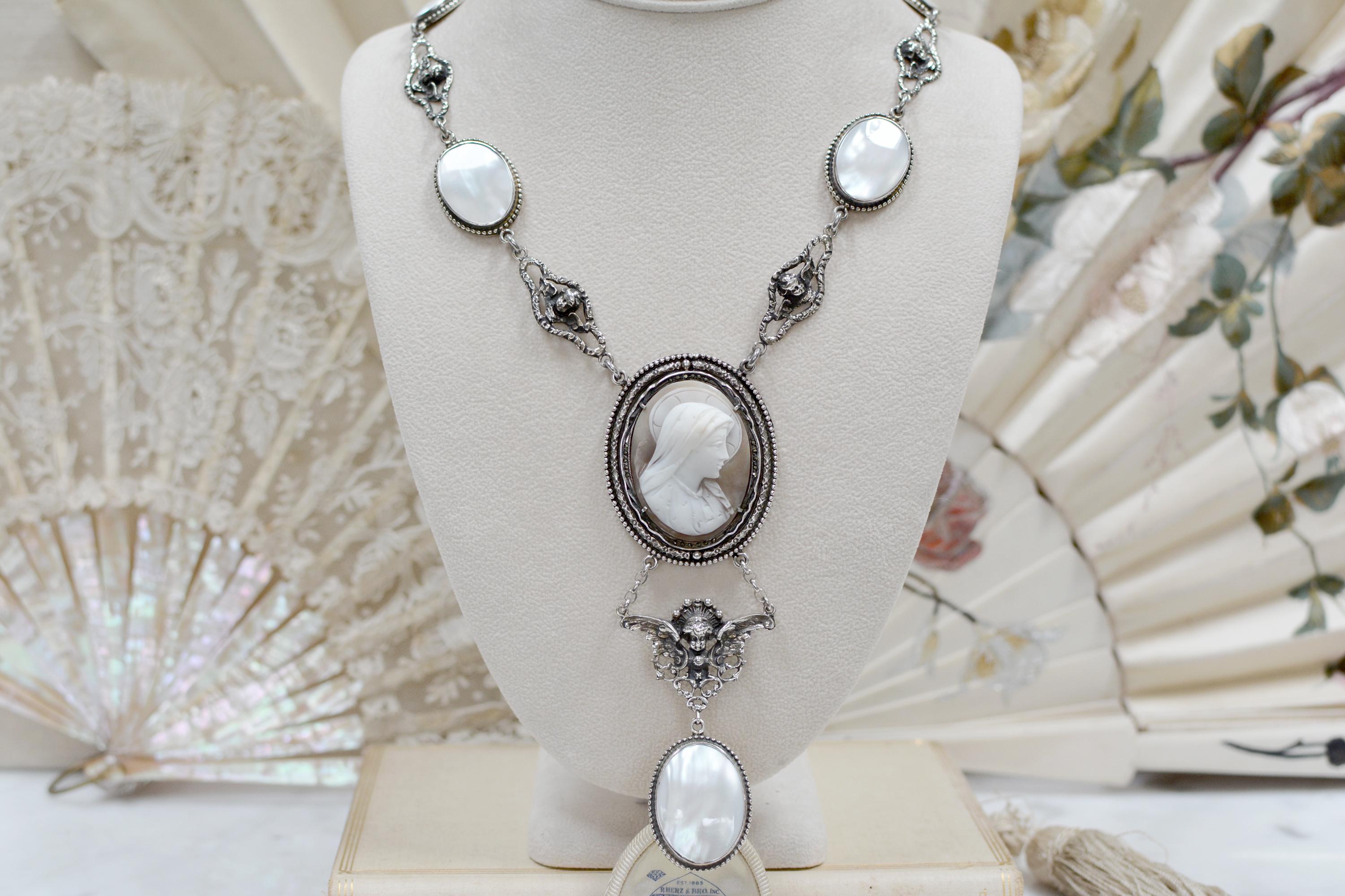 This exquisite lavalier style drop necklace by highlights a divinely hand-carved nineteenth-century Venetian cameo depicting Saint Mary which is framed in sterling silver with delicately engraved detailing and old-cut marcasites. The elaborate