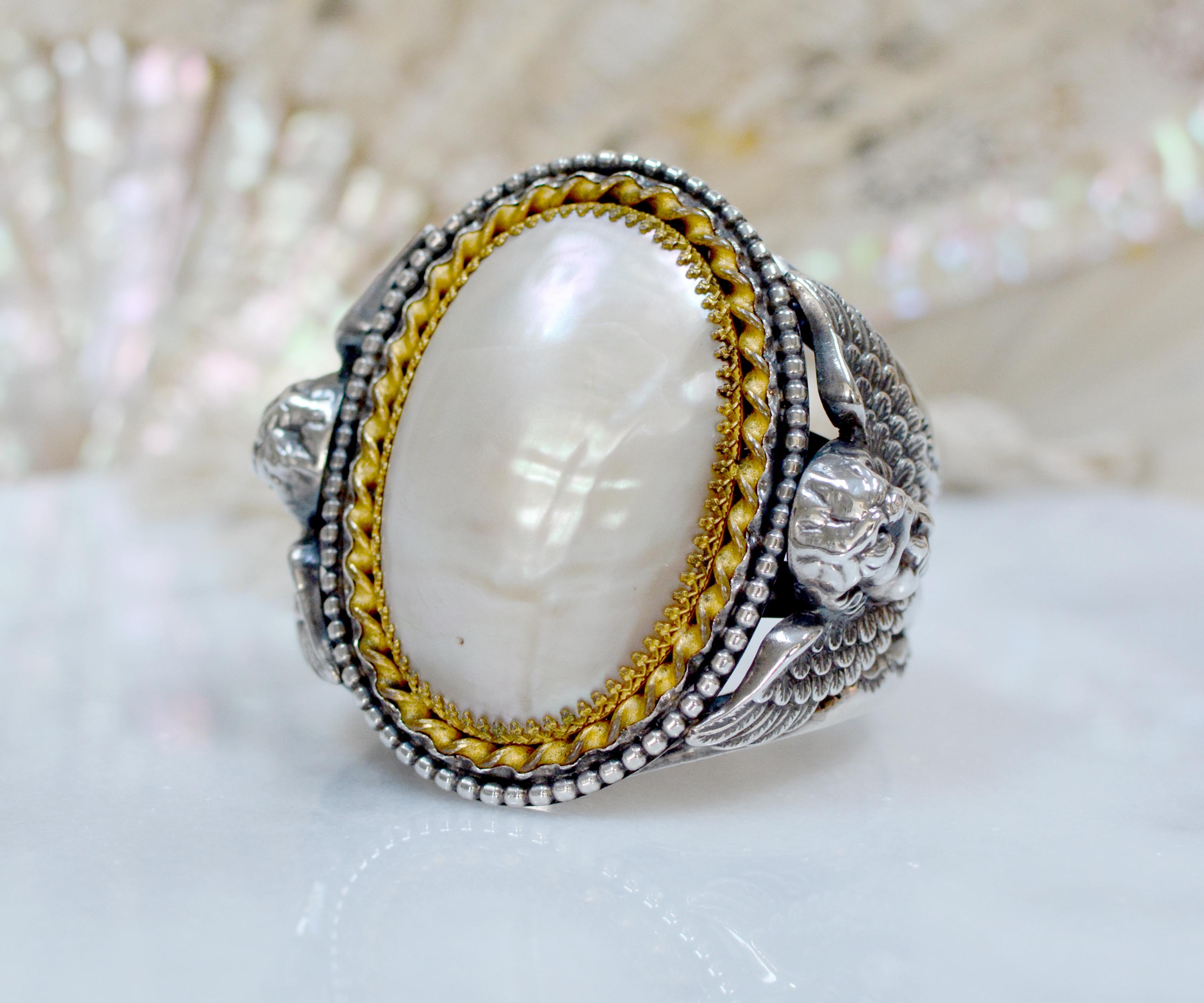 Jill Garber has designed this truly unforgettable, grand cuff bracelet around an exquisitely large nineteenth century Victorian high dome Mother of Pearl cabochon. Discovered in such lovely condition with meticulously engraved gold vermeil gallery