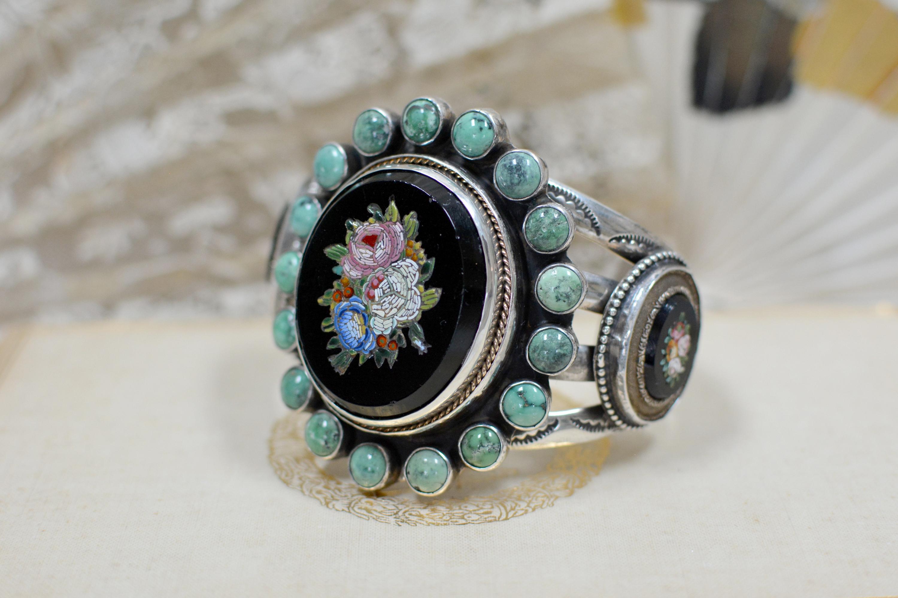 This meticulously hand crafted, one of a kind, sterling silver cuff bracelet features a large antique nineteenth century Venetian tesserae micro mosaic at its center. The mosaic bouquet has delightful shades of pink, yellow and and jade green