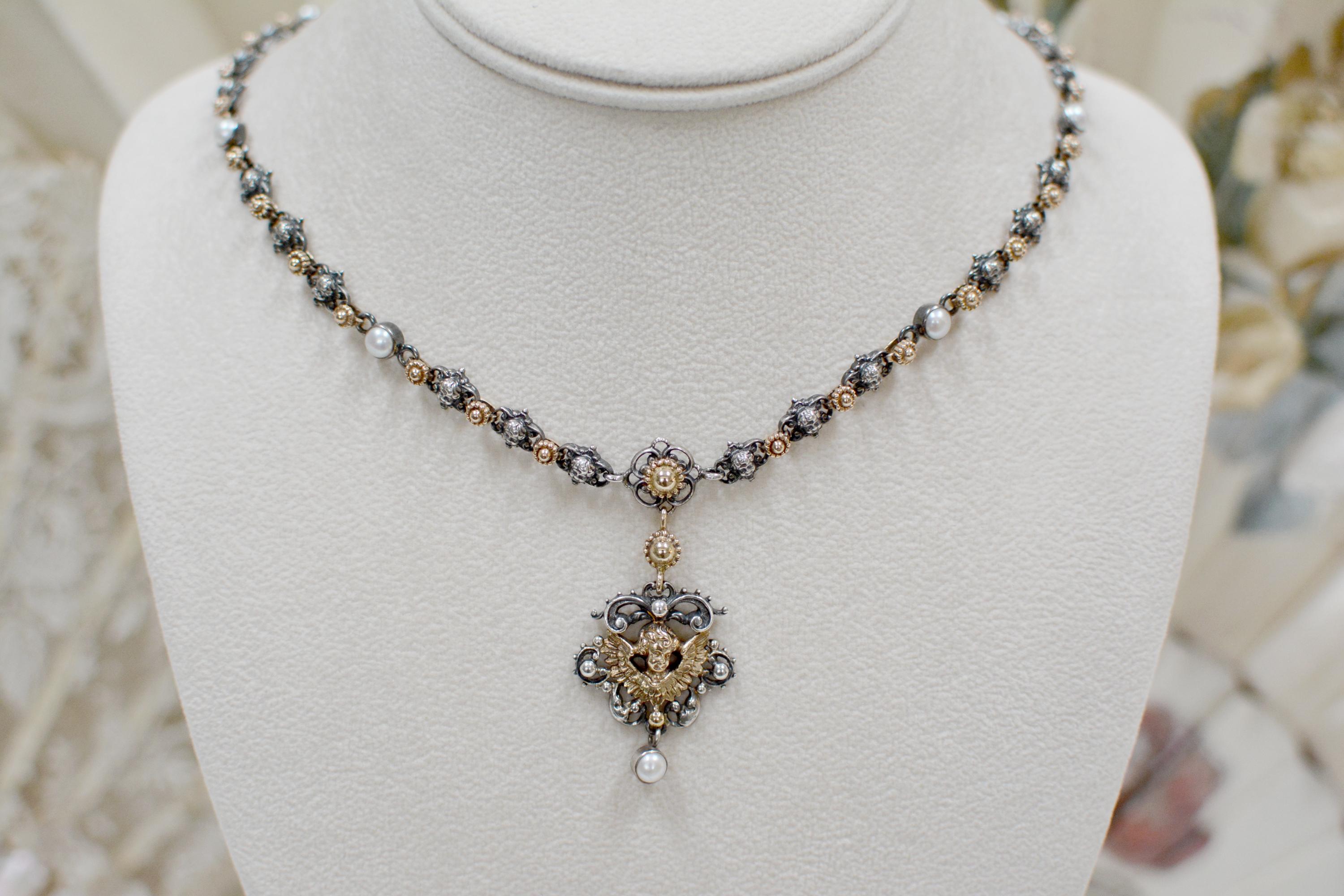 This exquisite Jill Garber drop necklace is comprised of twenty eight very fine figural cherub angel links, joined together by finely cast 14 karat gold flower links. Eight natural freshwater pearls are bezel set in sterling silver and evenly