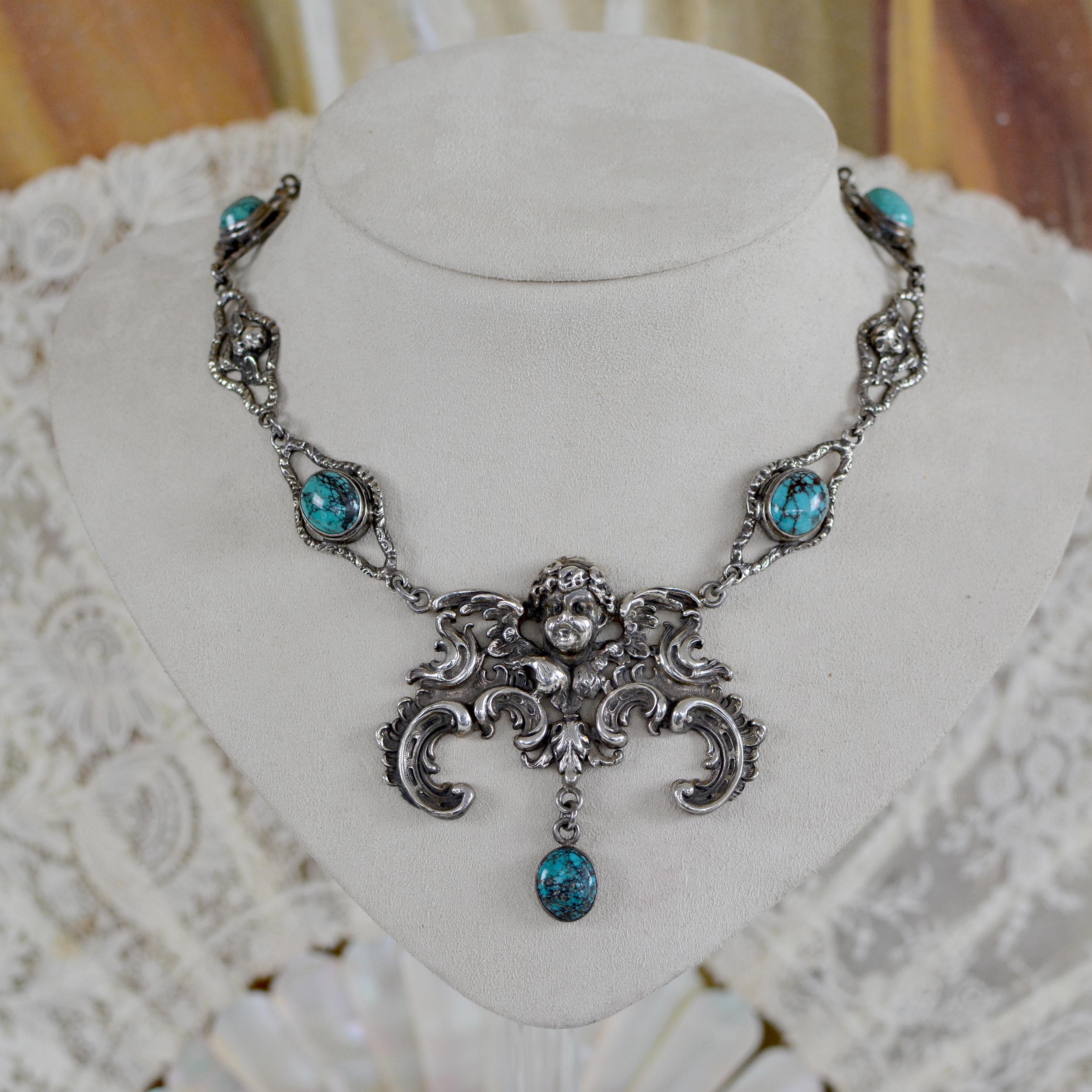 This one of a kind sterling silver drop necklace accentuates heavenly elements found in sacred adornments throughout history. An original grand figural angel with wings establishes the bold central drop for this ethereal necklace which has a single