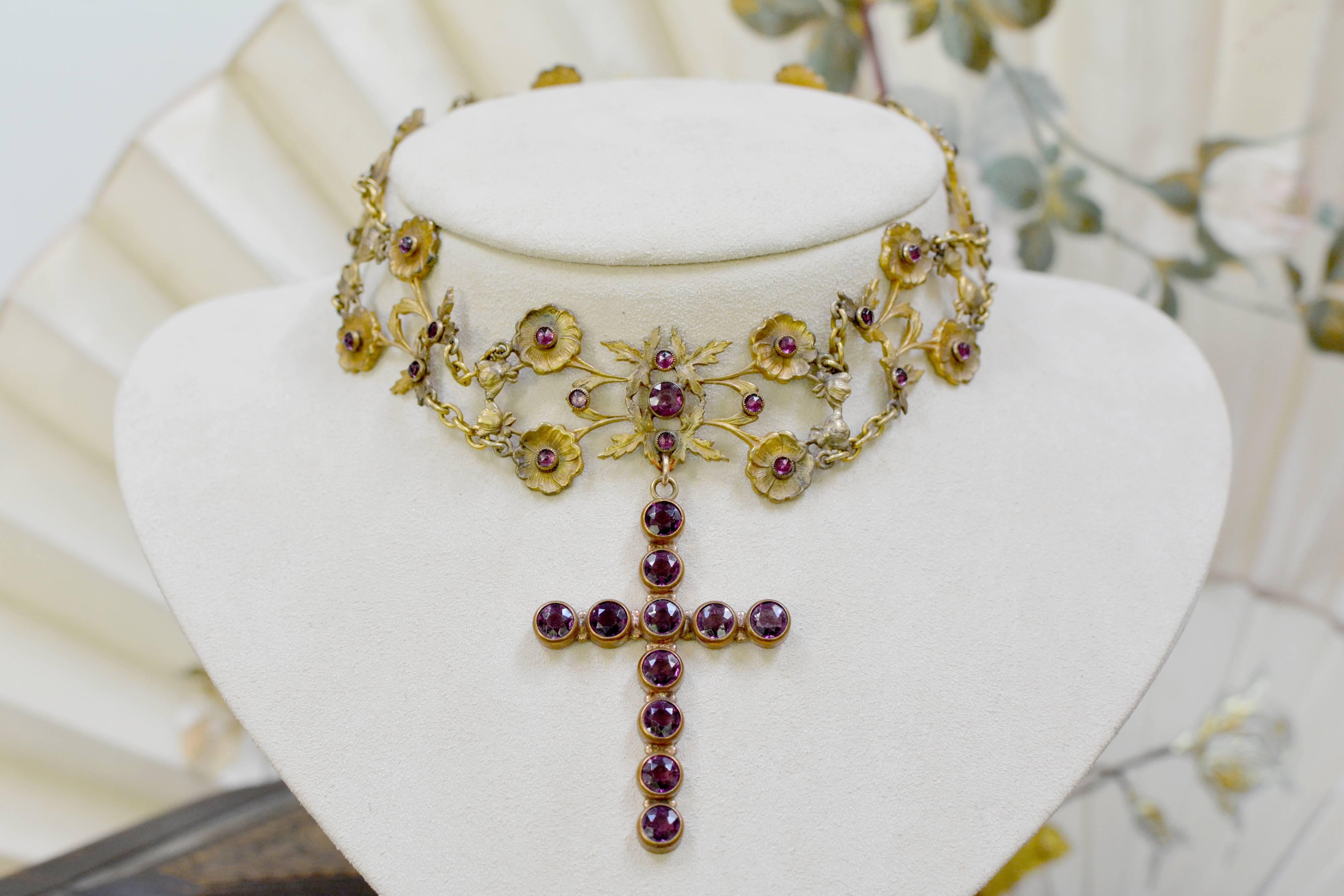 A fine original nineteenth century figural floral choker in gold vermeil with 33 faceted old cut, high dome paste amethyst forms the structure of this exquisite antique assemblage necklace. The large, old cut amethyst paste cross hangs 2.50 inches