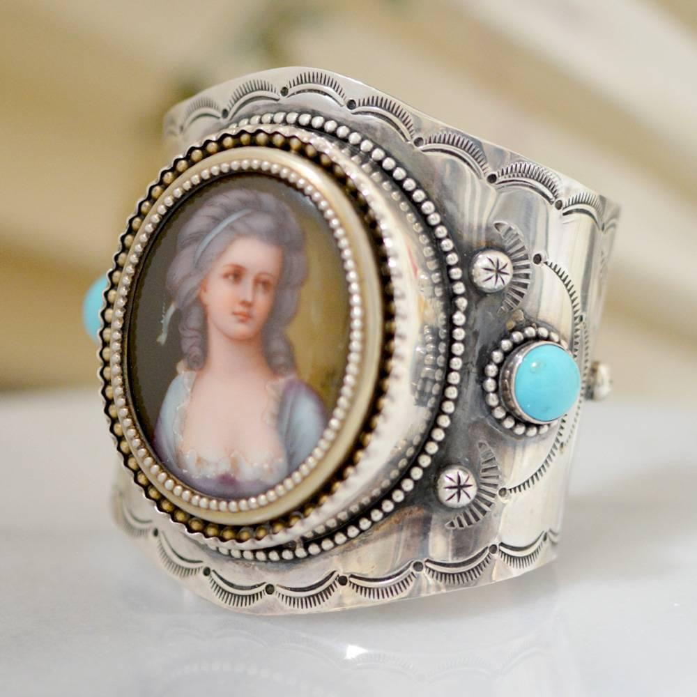 This one of a kind sterling silver cuff bracelet features a beautiful late eighteenth or early nineteenth century French portrait in its original gold vermeil frame with beaded detail. Two beautiful blue 12 mm high dome natural Sleeping Beauty