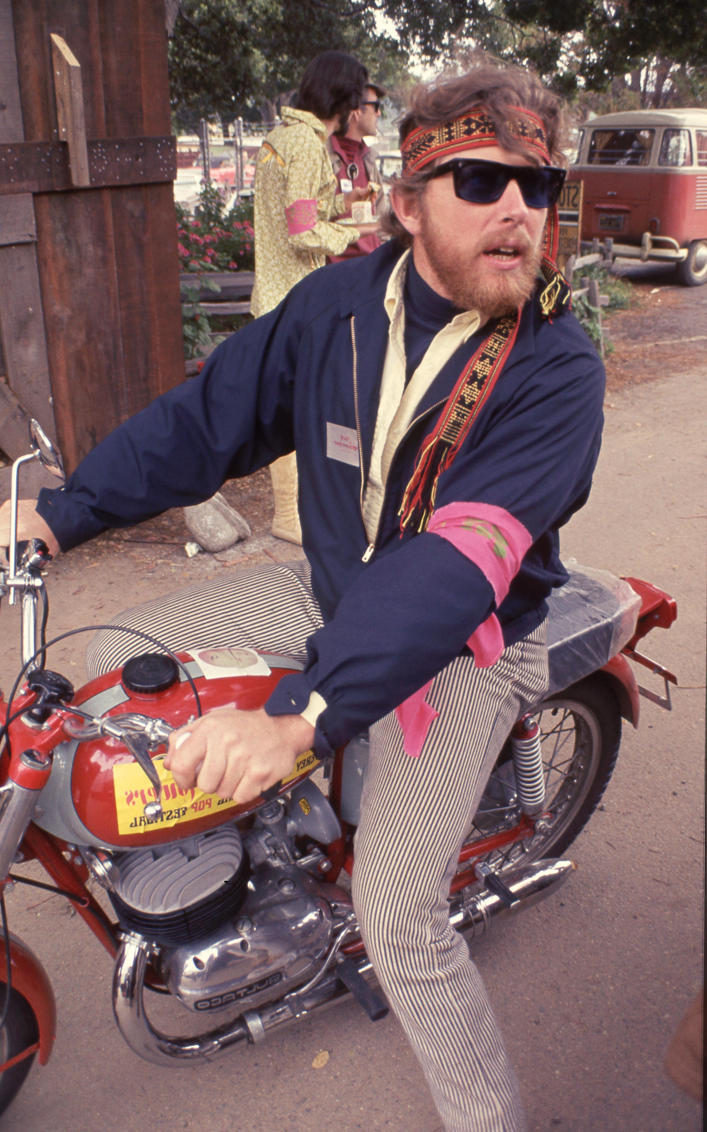 Jill Gibson Color Photograph - Hippie Riding Motorcycle, Monterey Pop Festival Fine Art Print
