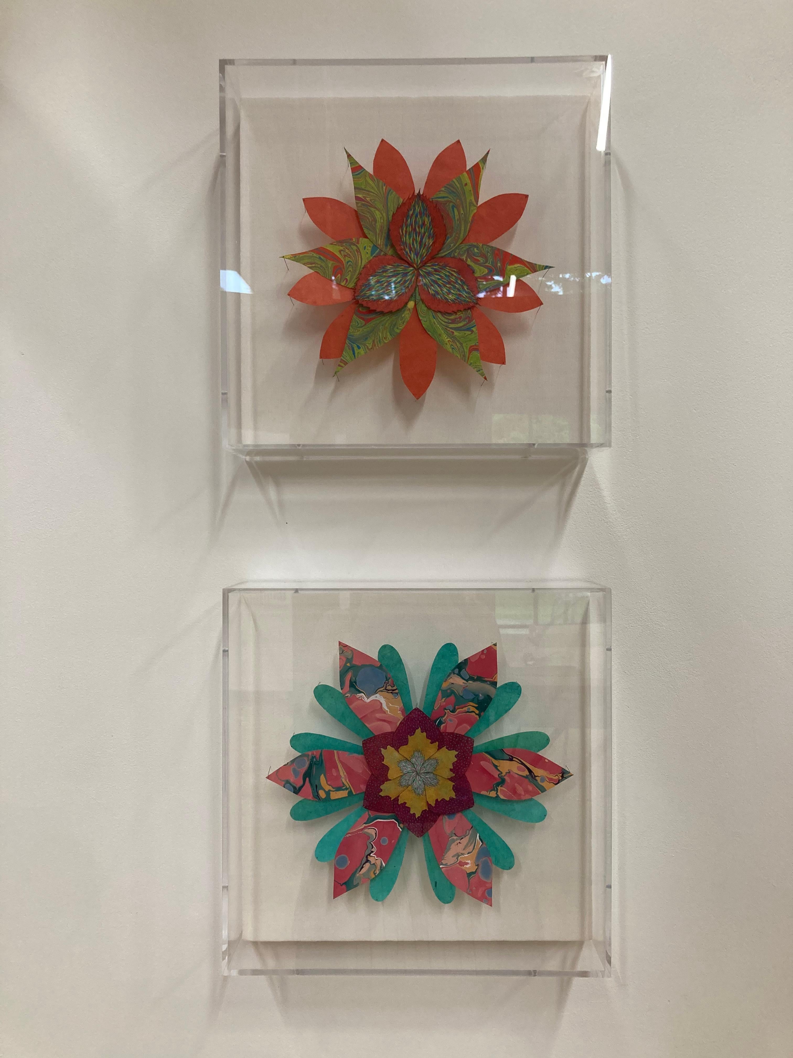 In this bright and colorful paper sculpture, a fantastical botanical form in vibrant teal green, dark magenta with gold and marbled pink, green, yellow and blue is composed of hand-colored etchings on hand-cut handmade Loktah paper chine colléd to