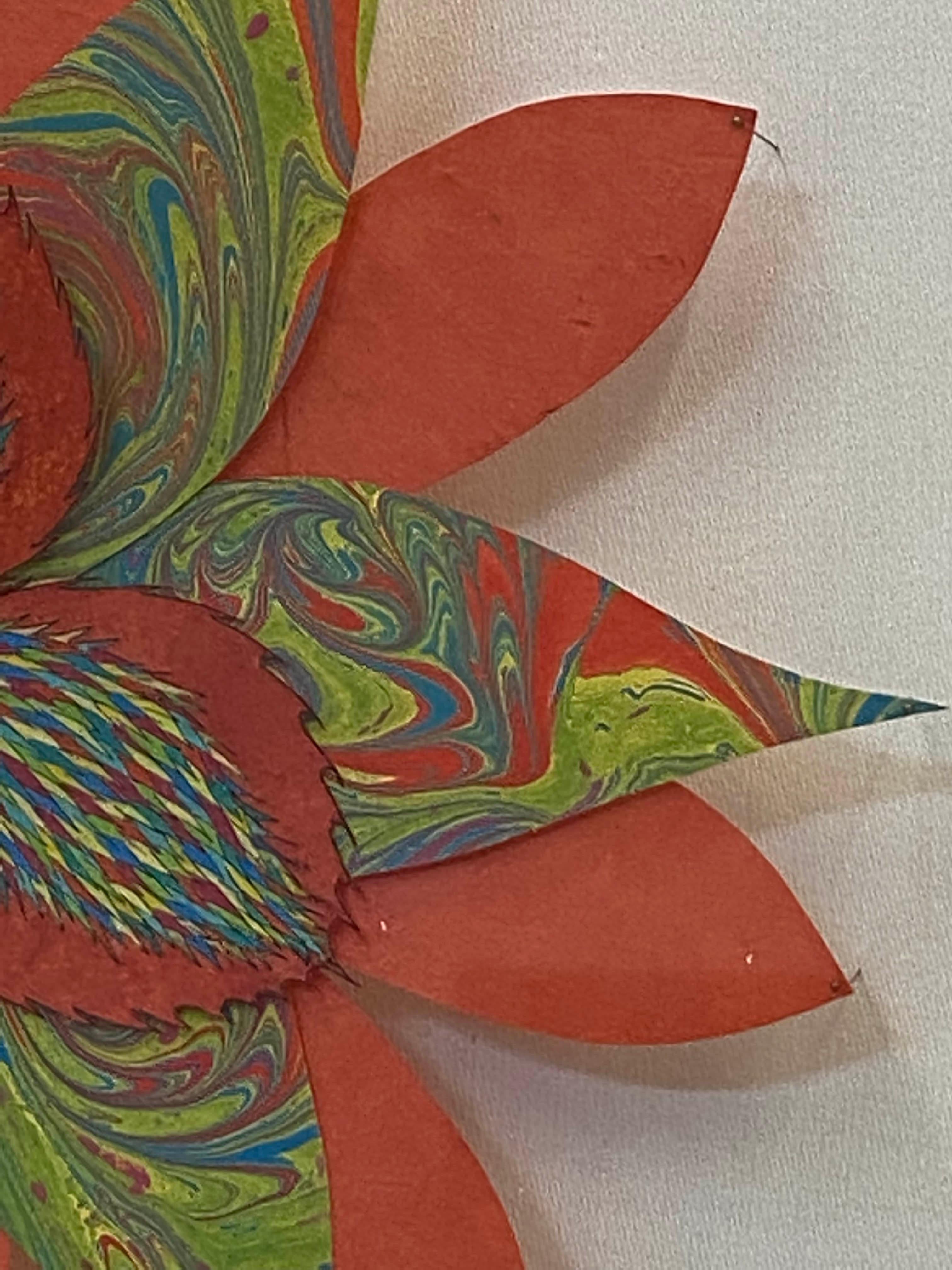 In this bright and colorful paper sculpture, a fantastical botanical form in vibrant orange, lime green, blue and yellow is composed of hand-colored etchings on hand-cut, handmade Loktah paper chine-collé to Rives lightweight paper, hand-cut marbled