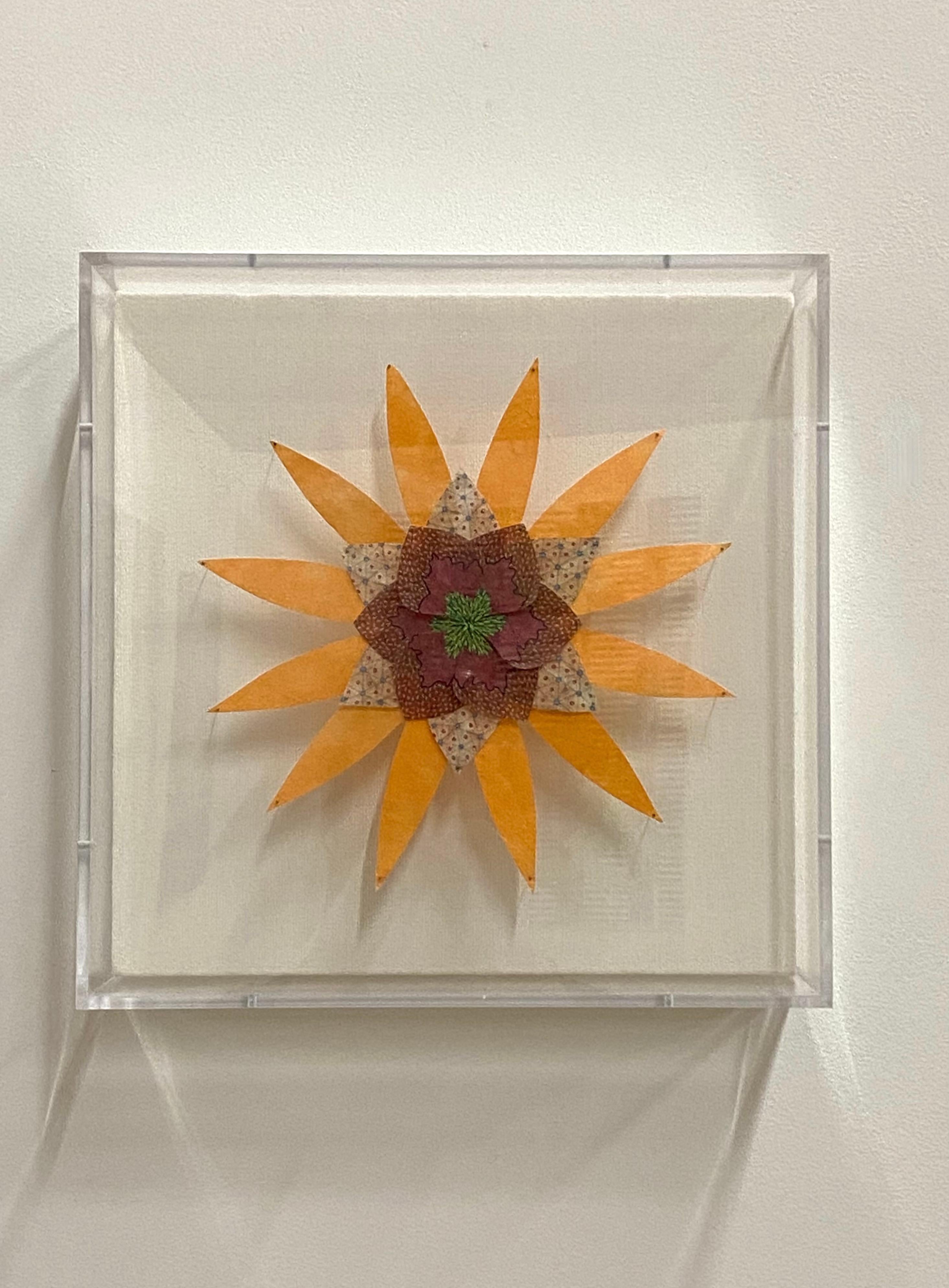 In this bright and colorful paper sculpture, a fantastical botanical form in light orange with dark burgundy, magenta and light brown in the center is composed of hand-colored digital prints on hand-cut, pigmented, handmade Loktah paper pinned with