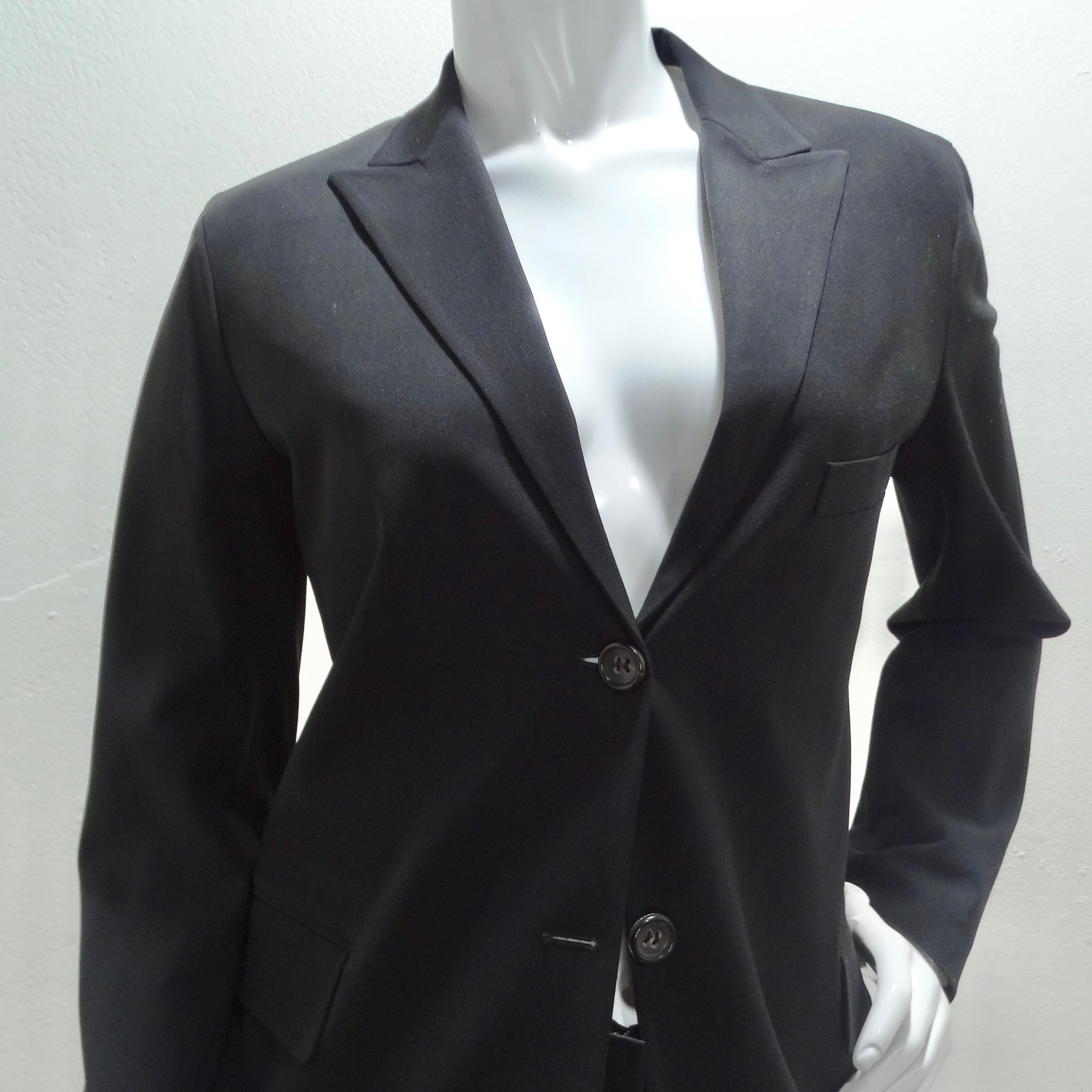 Elevate your style with this iconic Jill Sander 90s Black Blazer & Trouser Suit Set! Embrace the timeless sophistication of the classic black blazer, adorned with a collar, central buttons, and convenient pockets. The flattering straight-cut