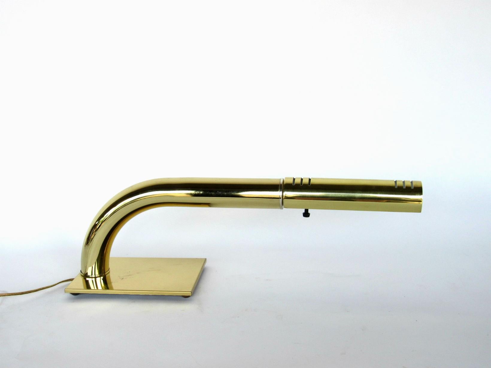 Jim Bindman for the Rainbow Lamp Company, American 1970s. Sleek brass desk lamp featuring a tubular design with directional shade resting on a cast iron base. The lamp is touch sensitive, tap anywhere on the lamp to control on/off and cycle through