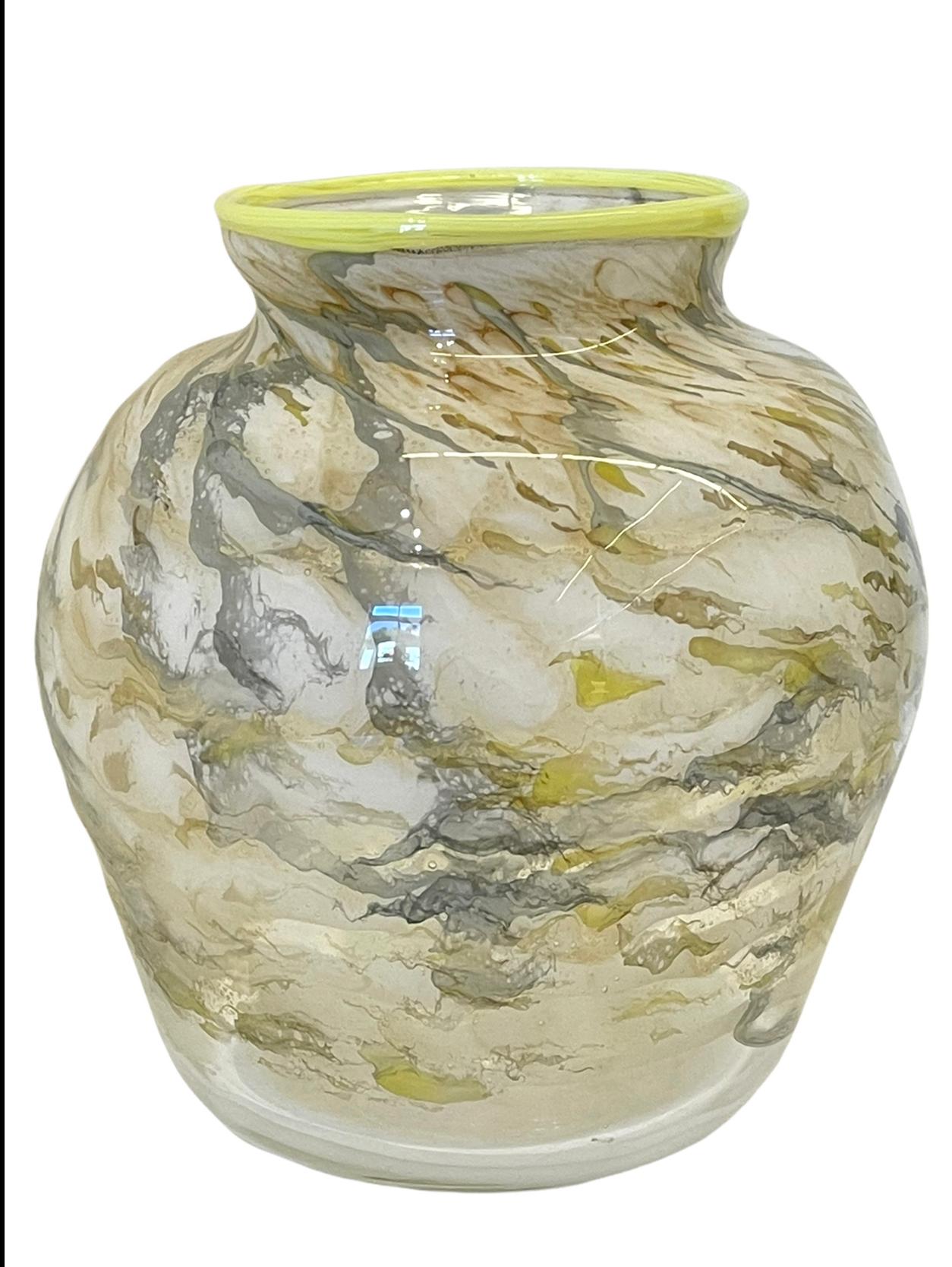 Measures: 8.25 x 7”Diameter

Beautiful signed art glass vase. Featuring ribbons of gold, grey and cream tones with a vibrant yellow/green ribbon around the top edge. Signed “Jim Bowman 95”.