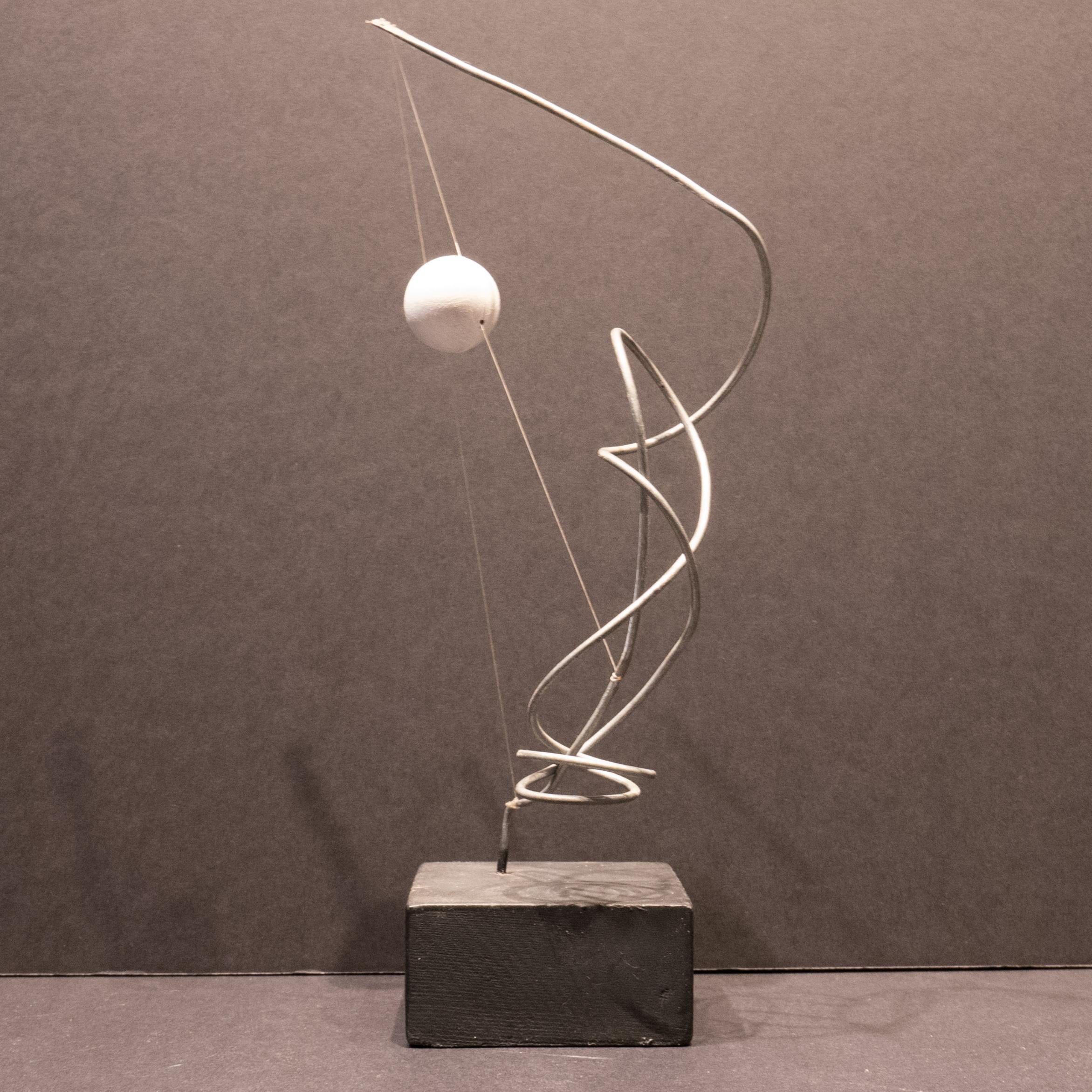 Abstract sculpture of bent wire with a painted wooden sphere suspended by fish line atop a wooden base, created circa 2010. Essentially a maquette, as Hunter always thinks about scaling up to landscape size. Hunter (born 1963) studied advertising