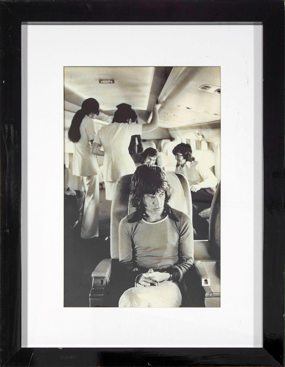 "Mick Jagger on Tour Plane 1972" black and white photograph by Jim Marshall. Image size: 22 1/2 x 14 1/2 inches. This framed photograph was previously displayed in a guest room of the Hard Rock Hotel and Casino in Las Vegas, Nevada, and comes with a