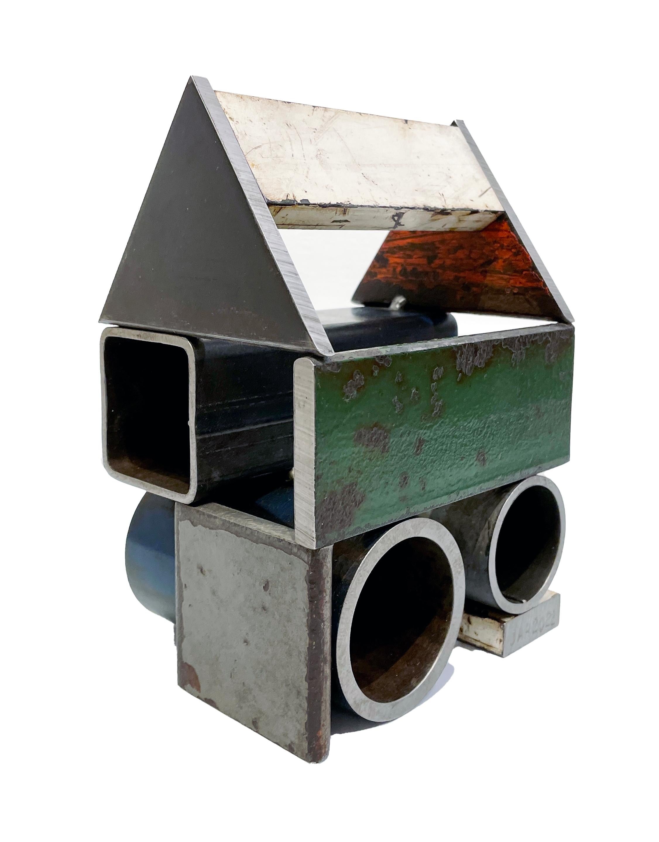 This is a welded steel sculpture made by furniture creator Jim Rose. It is sustainable design created from salvaged and recycled steel panels left over from his larger projects. These sculptures reference traditional American Folk Art barn house