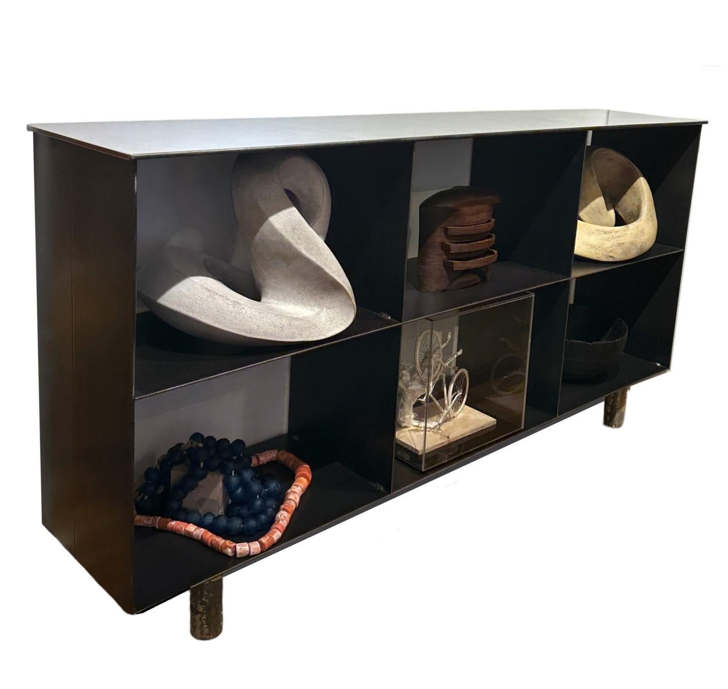 This is a totally functional six shelved bookcase made from repurposed steel, painted and hot rolled.  Modeled after Shaker furniture, this modern industrial statement piece is a model of sustainable design. There are six fixed shelves for an