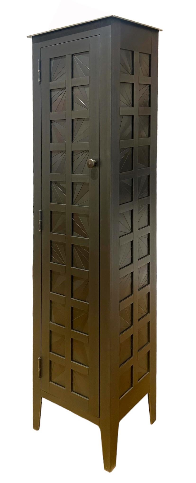 This is a totally functional tall one door cupboard. It created from hot-rolled steel panels. The panels on the door front and sides are made from welded pieces of steel arranged in a fractured starburst quilt pattern. The pattern is inspired by the