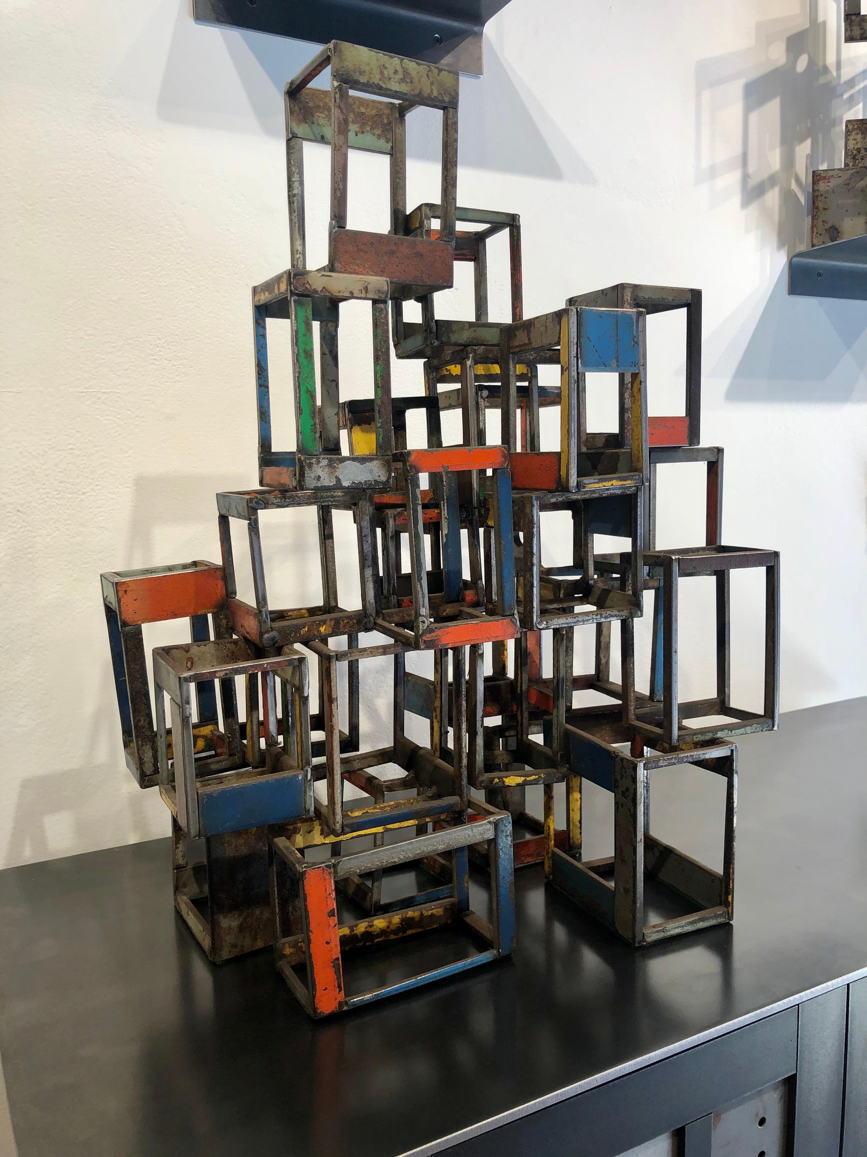 This is a welded steel sculpture made by Wisconsin based artist Jim Rose.  Using the same salvaged steel found in his renowned furniture, Jim combines various pieces of salvaged steel, taking advantage of the original painted and textured surfaces,