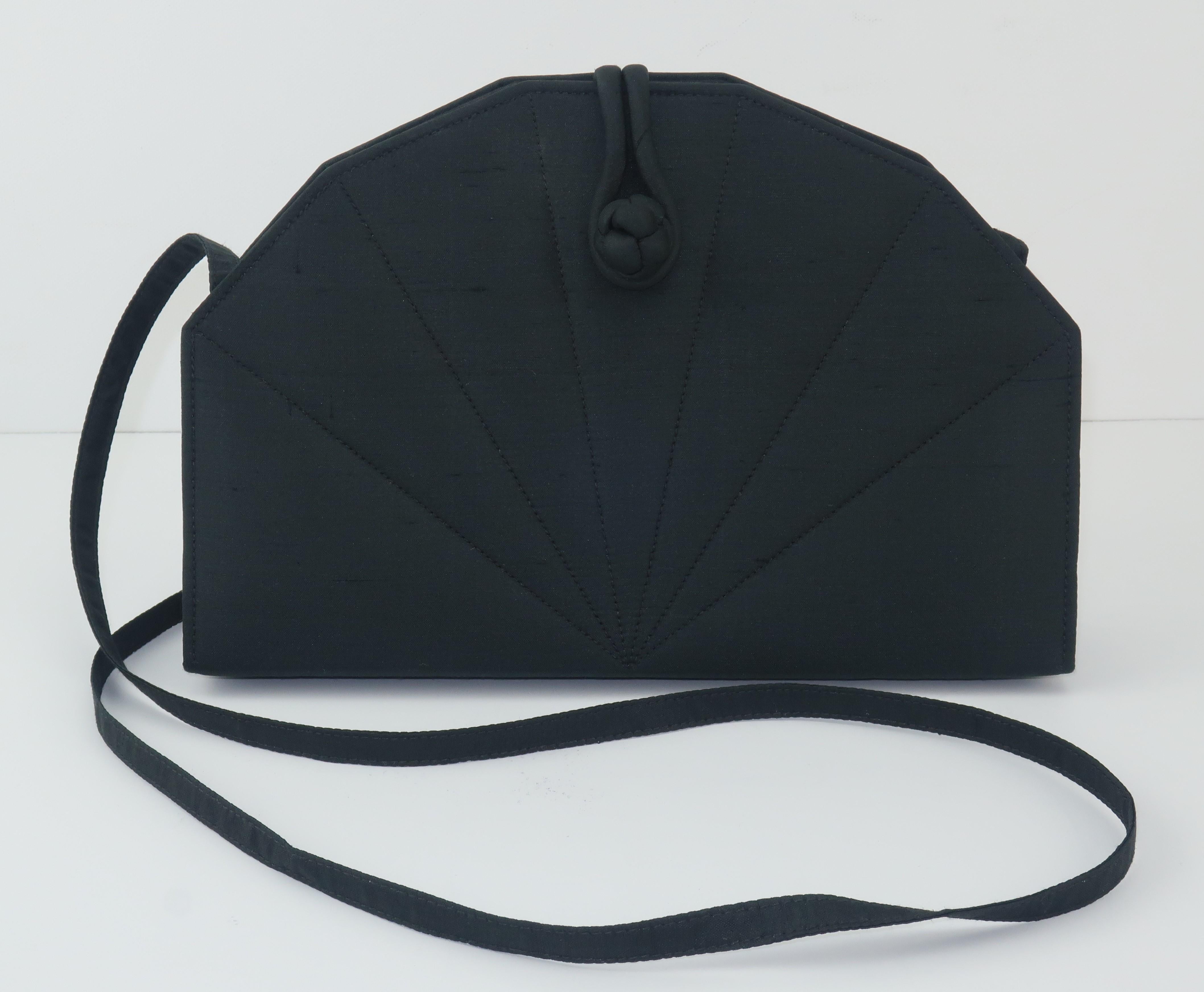 This lovely black fan shaped handbag was created by Jim Thompson Thai Silk Company, a name usually associated with fine fabrics for interior upholstery and home decor.  It is a simple design with a lightweight style that is suitable for day or