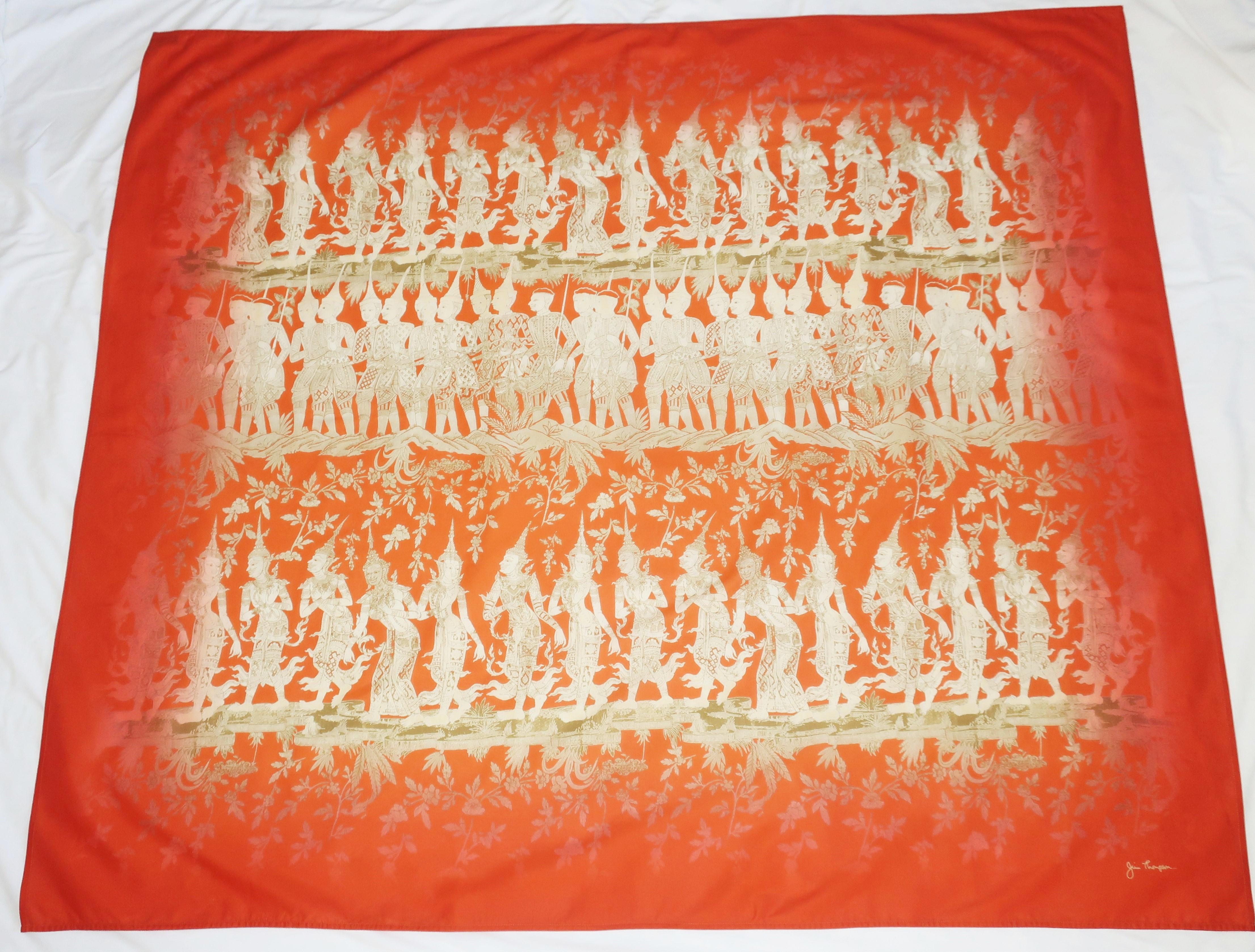 Jim Thompson fine cotton scarf in an extra large size that makes it suitable to wear as a sarong or shawl wrap.  The deep orange back ground is the perfect setting for a print depicting an ancient scene with figures in traditional Thai costumes