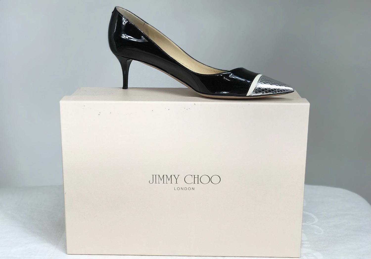 Jimmy Choo Anejo black patent leather, cream napa leather and silver metallic embossed snake, pointy toe pumps, 36 1/2.  2 inch heel. Leather sole, leather lined.  In excellent pre worn condition, look barely worn. Box and protector bag included. 