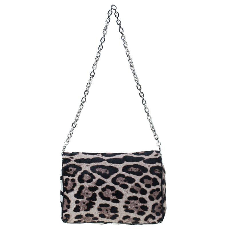 Add a touch of wildness to your wardrobe with this exotic animal printed shoulder bag by Jimmy Choo. The dual animal printed pony hair exterior is accentuated with silver-tone studs and crystal embellished python leather flap front. It comes with a