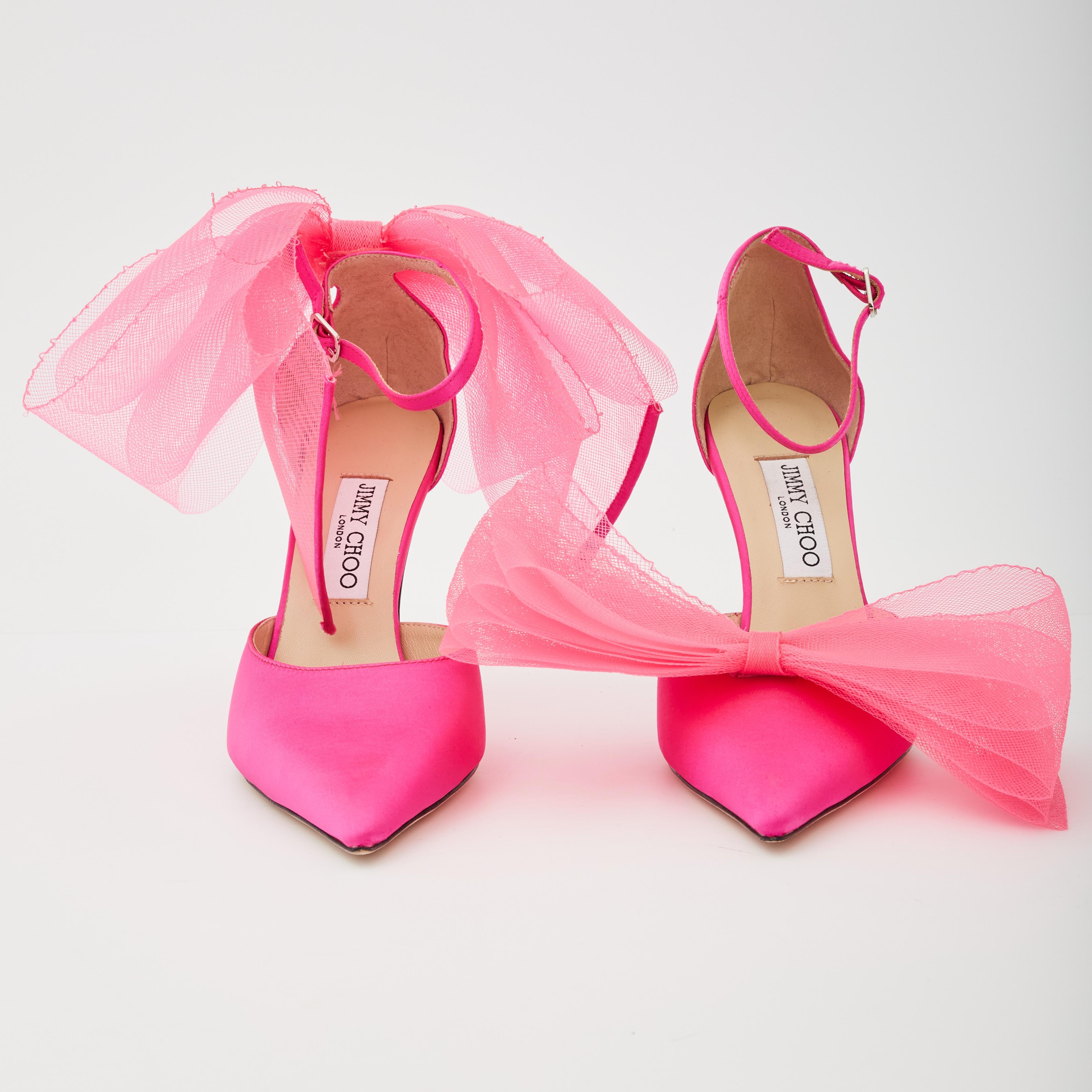 These asymmetrical Averly pumps are made with fuchsia grosgrain and decorated with two oversized bows that are intricately woven, hand tied and sewn on for a dramatic finish. The slim heel and ankle strap with side buckle fastening make for a