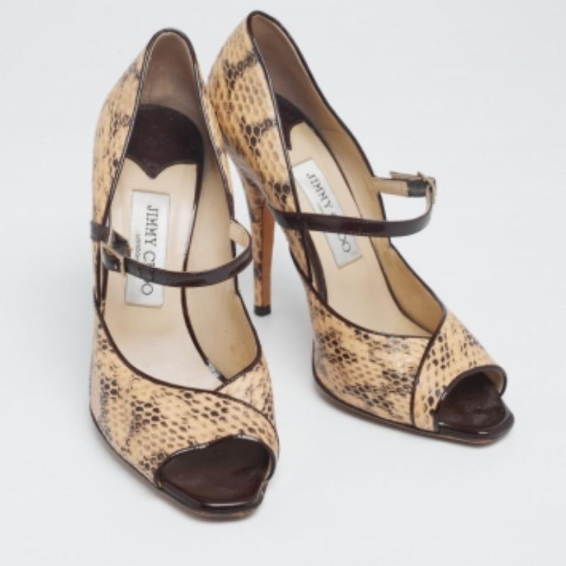 These Mary Jane pumps from Jimmy Choo will certainly make you look classy and polished! They are created using beige-black python leather on the exterior. They showcase slim heels, a buckled strap, and gold-tone hardware. Look gorgeous as you wear