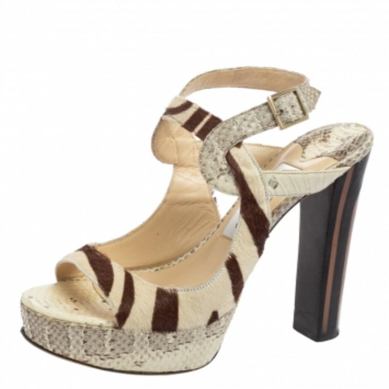 These sandals from the House of Jimmy Choo bring style and sophistication to your feet effortlessly. They are made from beige-brown python leather and pony hair on the exterior. They showcase platforms, open toes, and gold-tone hardware. To add a