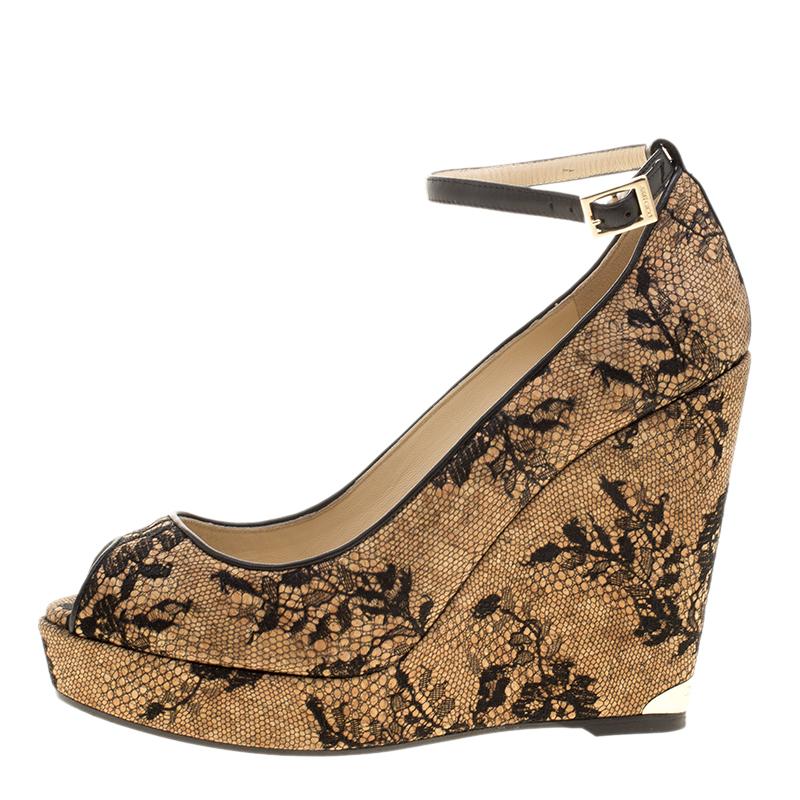 Dress it up for the formal parties and ease it down for the day time events, these Jimmy Choo pumps are a must have for style with comfort. Constructed in beige leather and cork wedge heels, these shoes feature a black lace covering all over along
