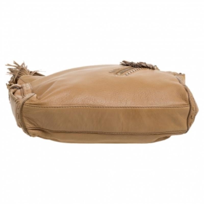 Crafted from beige-hued leather, this stylish Lily hobo from Jimmy Choo comes with a zip pocket to the front with a lovely tassel zipper pull. It features a shoulder strap and the zip-top closure opens to reveal an Alcantara-lined interior that is