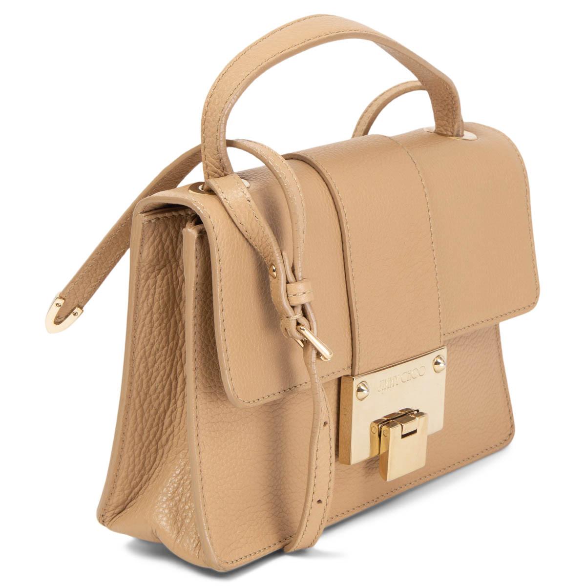 100% authentic Jimmy Choo Rebel Crossbody Bag in grained sand calfskin and light gold-tone hardware. Lined in beige alcantara with one patch pocket against the back. Comes with an adjustable shoulder-strap and top-handle. Has been carried and is in