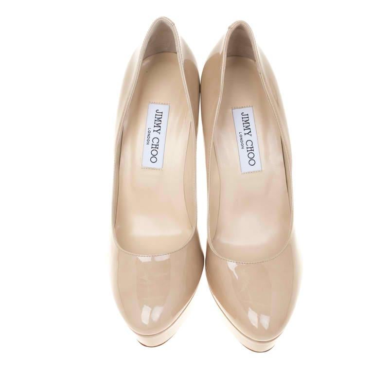 From the house of Jimmy Choo comes this gorgeous pair of pumps that is well-made and absolutely flaunt-worthy. They've been crafted from beige patent leather and styled with platforms, insoles meant to give you comfort and 12.5 cm heels to lift you