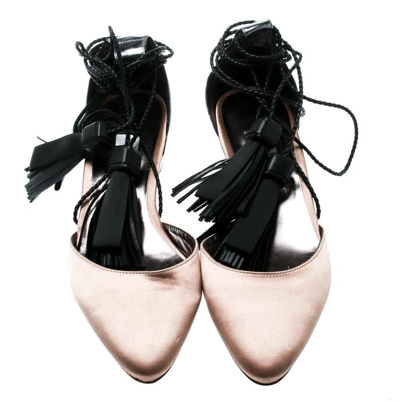 These Duchess sandals from Jimmy Choo are simply amazing! The beige sandals have been crafted from satin and metallic grey leather and feature almond toes. They have been styled with tassel detailed ankle wraps and come equipped with comfortable