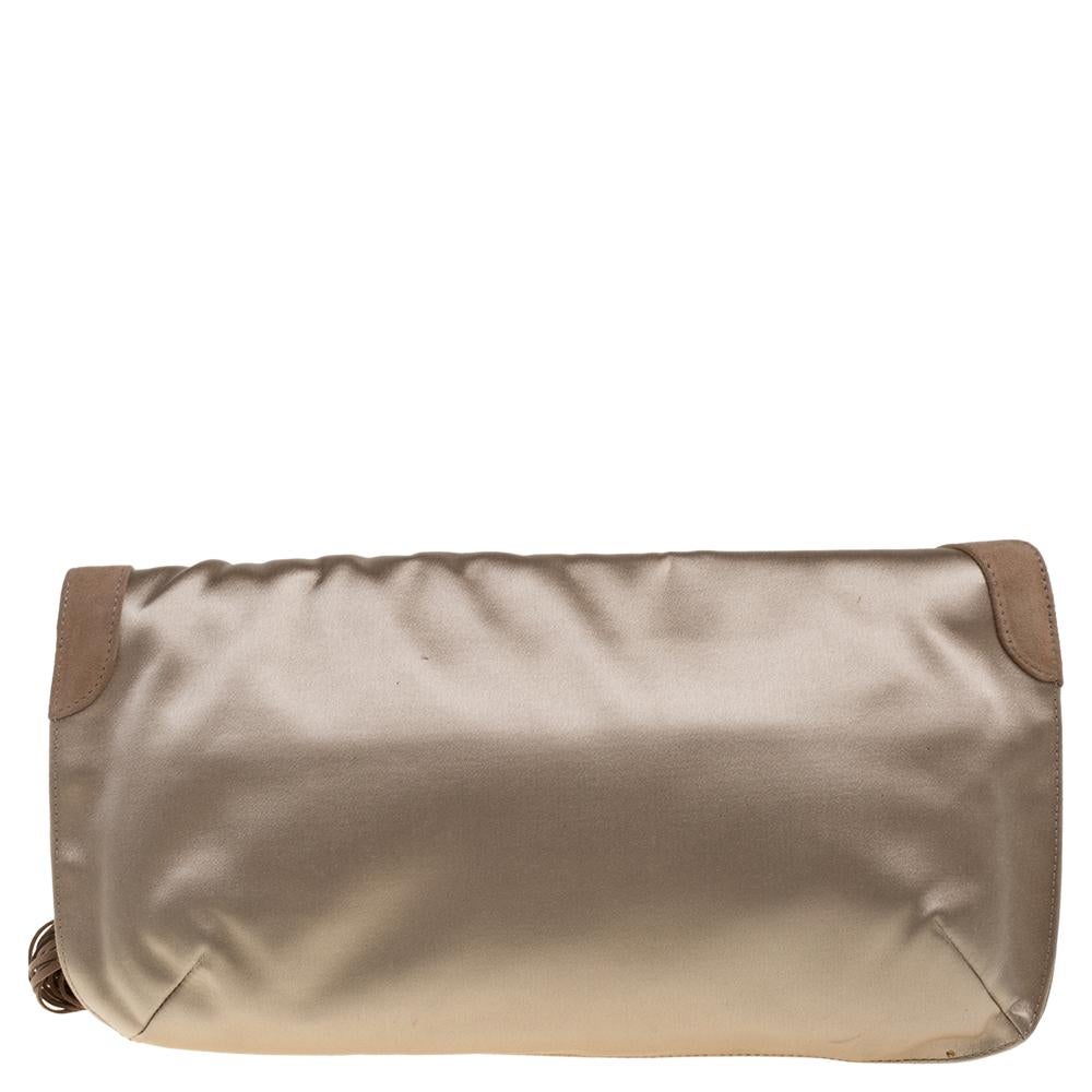 Complement your look with this gorgeous Carissa clutch from Jimmy Choo. Made from beige satin it features a ring detail and tassel at the front. The interior is satin-lined and houses a zip pocket that will keep your essentials safe. Team it up with
