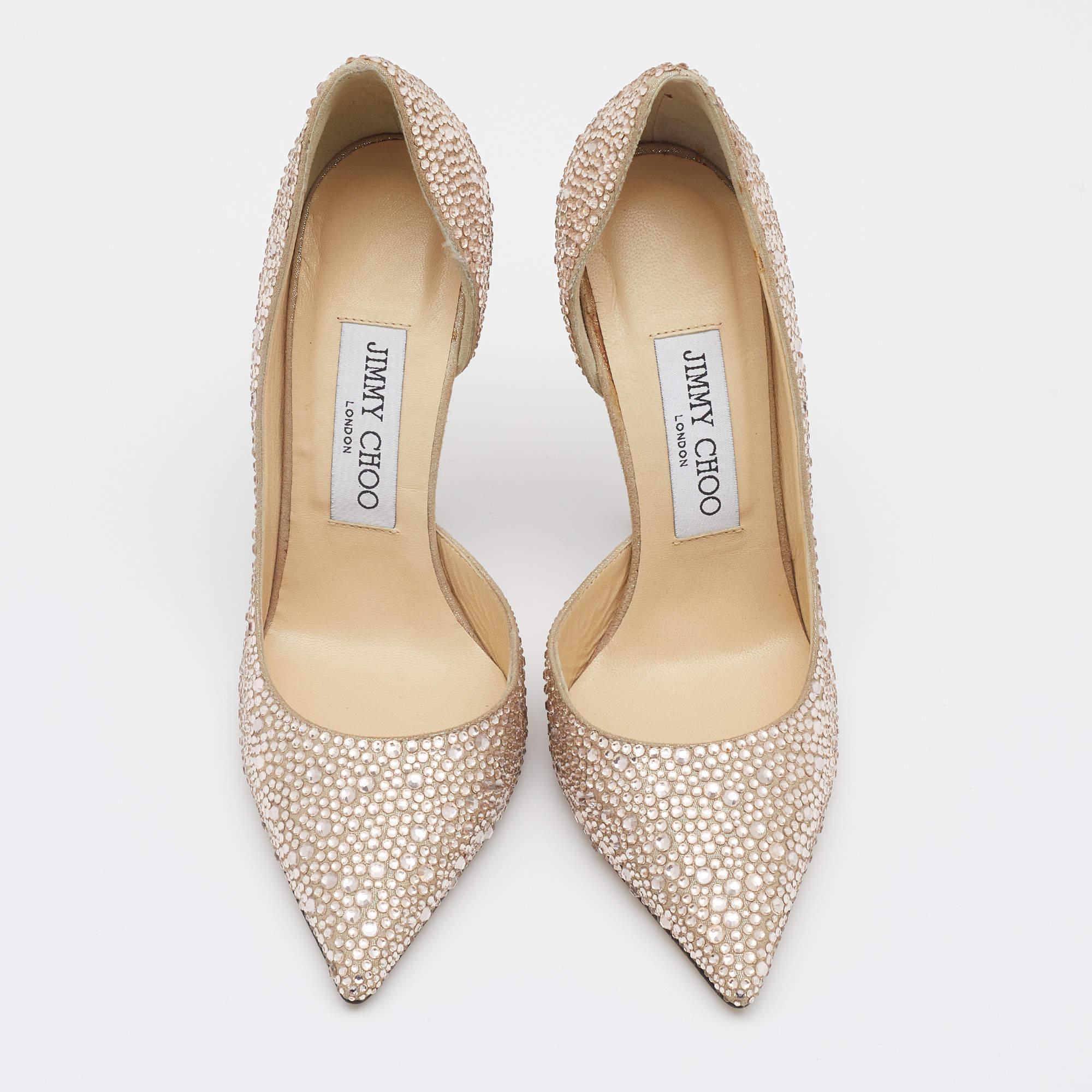 Jimmy Choo’s glamorous spirit enlivens in these stunning pumps that will add oodles of style to your ensemble. Crafted from beige suede, these d'Orsay pumps are embellished with crystals all over on uppers for an opulent touch. These gorgeous