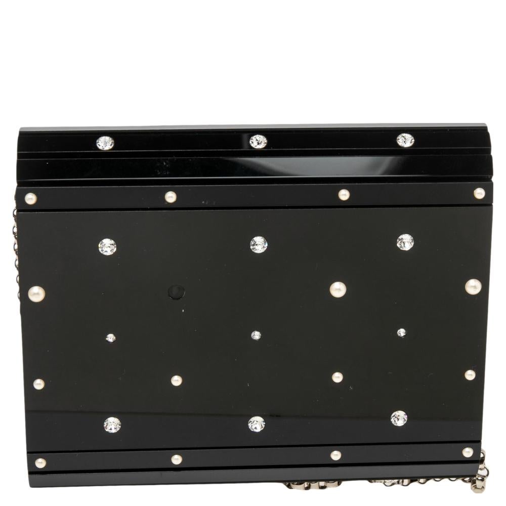 Classy and super stylish, this clutch bag is a Jimmy Choo creation. It is crafted from black acrylic and decorated with crystals. The insides are lined and sized to carry your necessities. The clutch bag is complete with the brand label on the flap,
