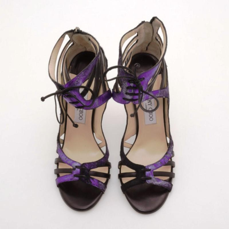 Wear these Black and Purple Darcy Sandals by Jimmy Choo whenever you need a colorful and edgy finish. These cut out style sandals are crafted from purple and black pony hair and leather, they are finished with lace up ankle straps, rounded toes, and