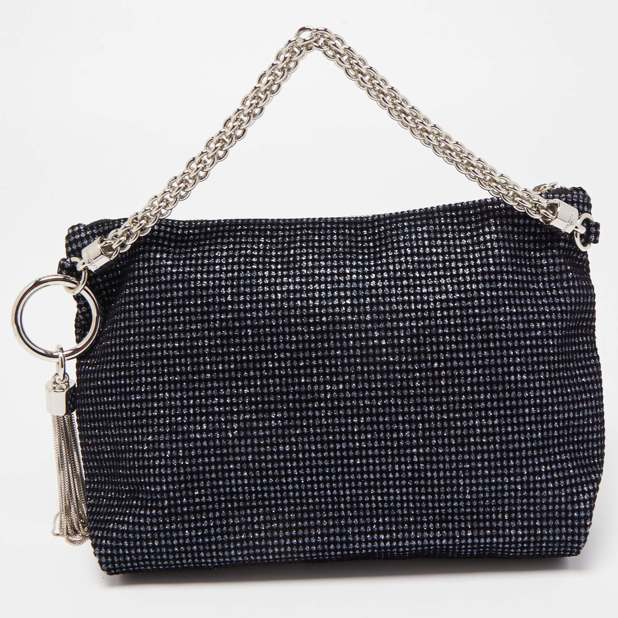 Just right for conveniently storing your valuables without weighing your look down, this Jimmy Choo clutch features a lurex fabric exterior with a chain handle. Carry it in your hand as a stylish day-to-evening accessory.

