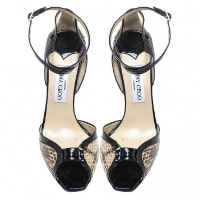 Nous sommes tombées amoureuses de ces sandales de Jimmy Choo ! Confectionnées en peau de serpent crème et en cuir verni noir, elles sont dotées d'empeignes bien dessinées, de brides de cheville à boucle et de talons de 11,5 cm. Très tendance, cette