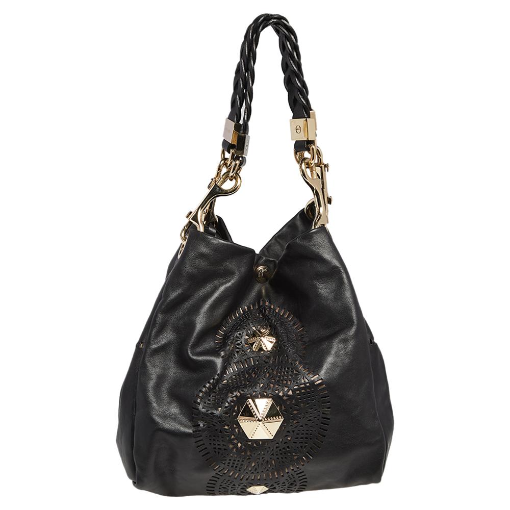 Crafted from leather, this black Jimmy Choo tote comes with a spacious Alcantara-lined interior and cut-out details on the exterior. The bag is equipped with two handles and gold-tone hardware. Swing this beauty wherever you go to lend your outfit