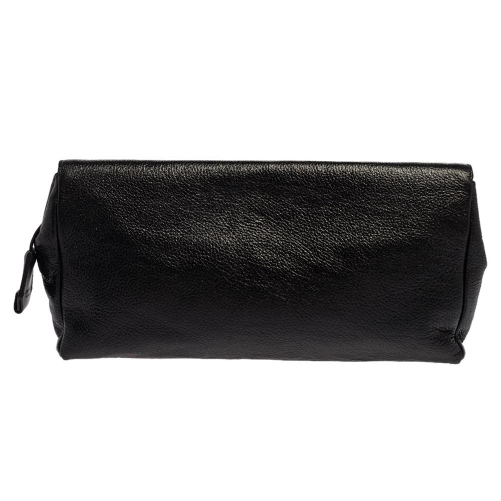 Jimmy Choo brings you this gorgeous clutch that has been crafted from pebbled leather and styled in a flap design. It carries a glossy black shade, a well-sized Alcantara interior, and gold-tone hardware on the front.

Includes: Authenticity Card