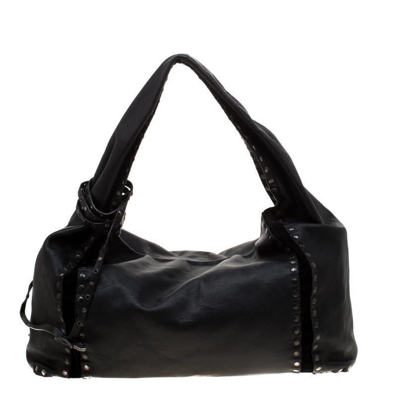 This Jimmy Choo Saba hobo is a stylish fashion-forward handbag that has been one of the most popular designs. It is crafted from black leather and suede trims that stands out with the stud details in black-tone hardware adorned over the exterior.