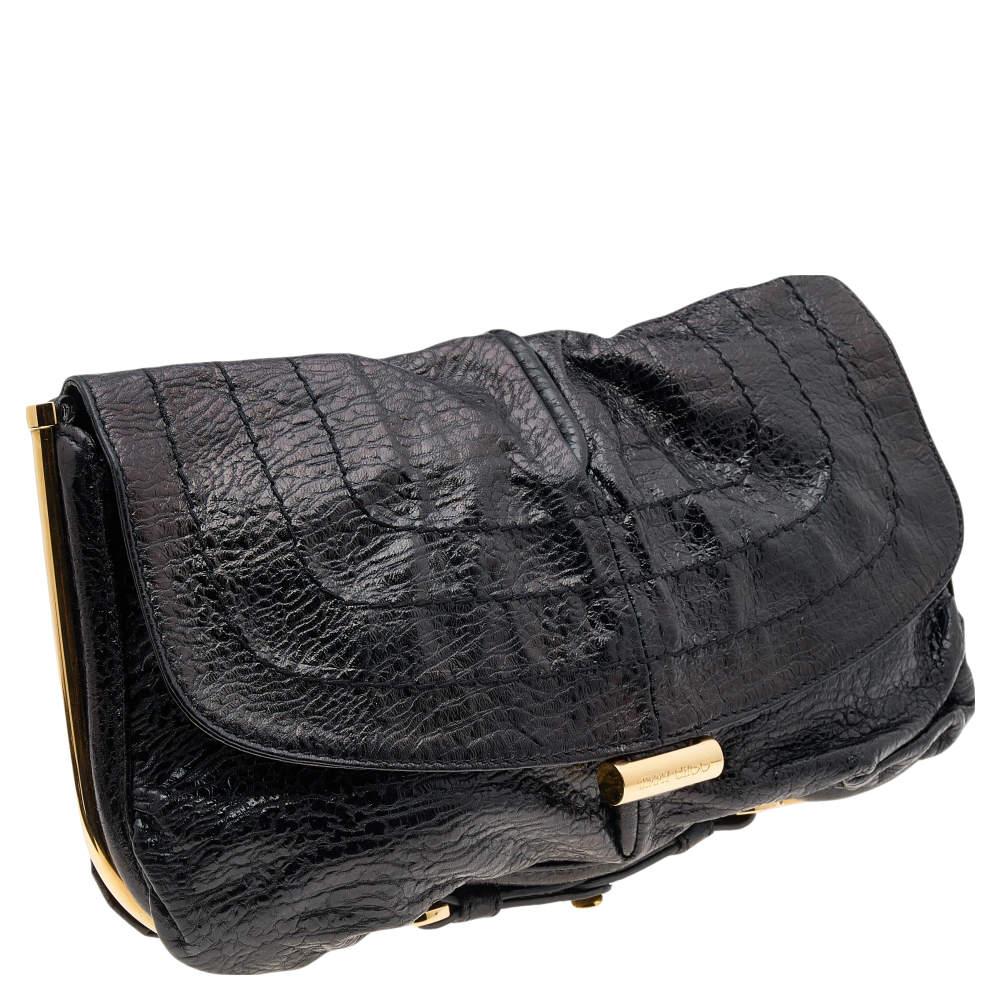 This Jimmy Choo Ayse bag has a black leather exterior contrasted beautifully with gold-tone hardware. The interior is lined with Alcantara and sized to comfortably hold your day's requirements.

