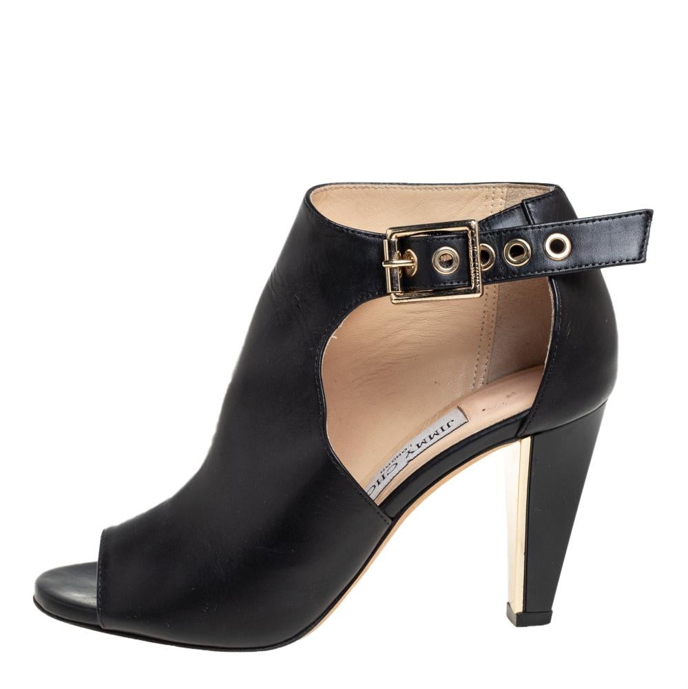 When comfort meets style, we get these stunning boots by Jimmy Choo, a brand famous for its artistry in shoemaking. Crafted from leather in a black shade, they feature open toes, belt fastening at the ankles detailed with gold-tone hardware. These