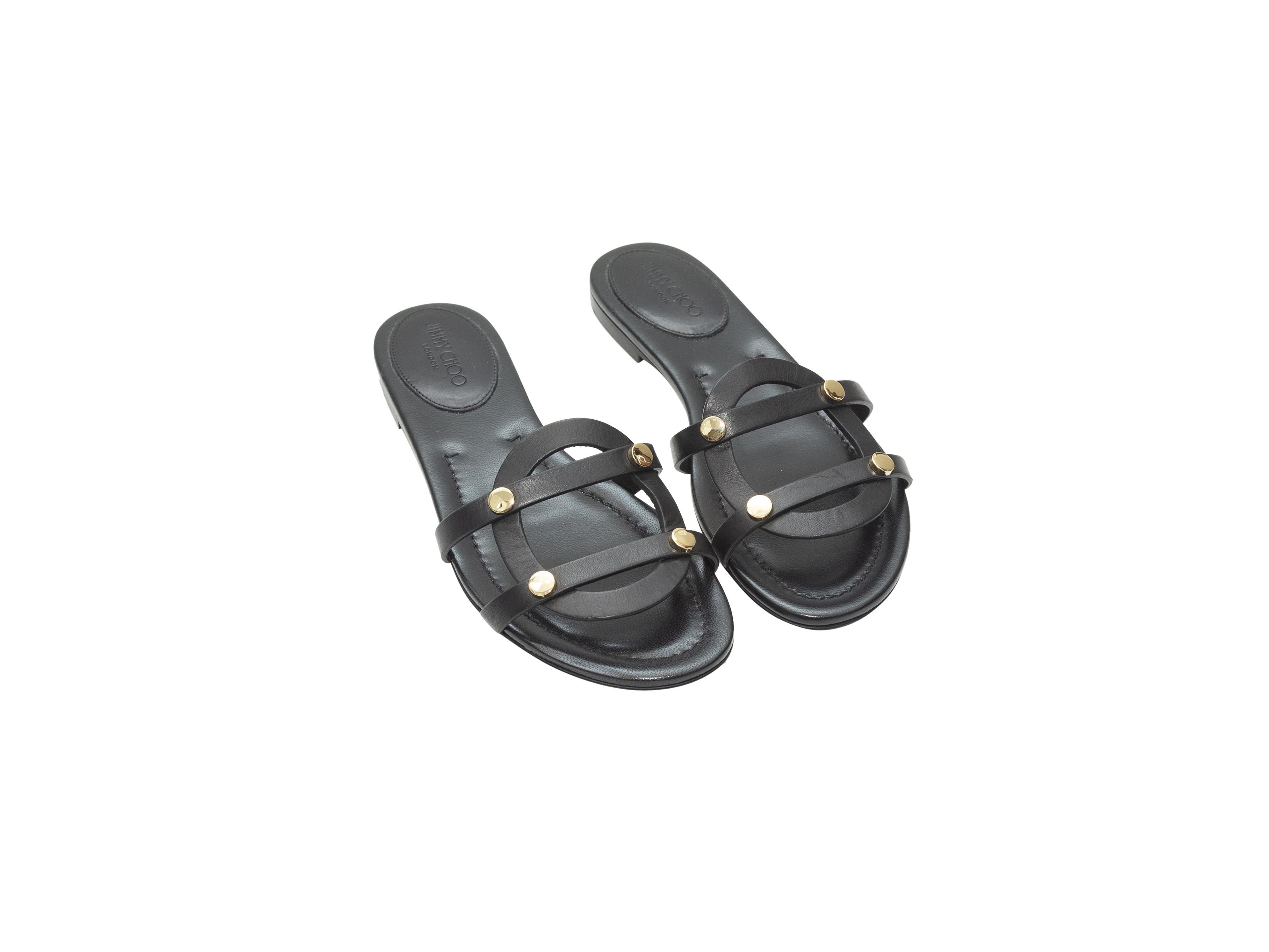 Product details: Black leather flat Damaris slide sandals by Jimmy Choo. Gold-tone stud adornments at tops. Designer size 37.5. 0.25