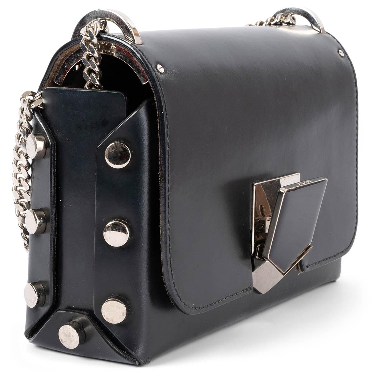 100% authentic Jimmy Choo Lockett Petite shoulder bag in smooth black leather featuring silver-tone hardware. It opens by a patented push-lock clasp to a brown suede-lined interior. The design comes with a knot chain strap and metal studs on the
