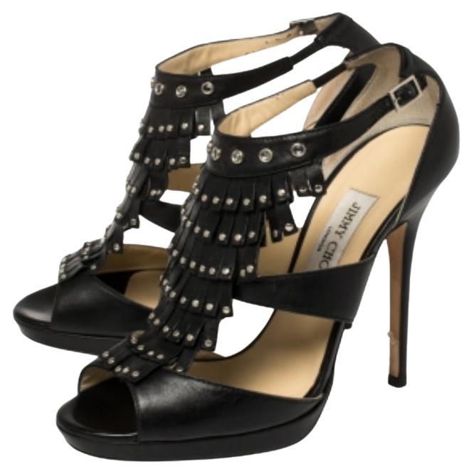 The stunning stilettos from Jimmy Choo are the emblematic essence of femininity at its finest. These sensual black leather pumps flaunt the swinging fringes at the front and are elegantly embellished with gunmetal-tone studs on the fringes and