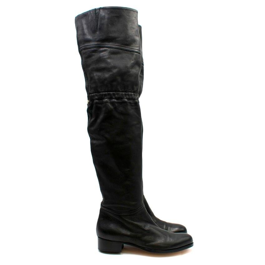 Jimmy Choo Black Leather Thigh High Boots

-Black flat thigh high boots
-Elasticated band at the knee
-Side zip closure
-Silver tone embossed plate

Approx.

Length - 26cm
Width - 10cm
Height - 66cm

SIZE 39 / US 6

Leather