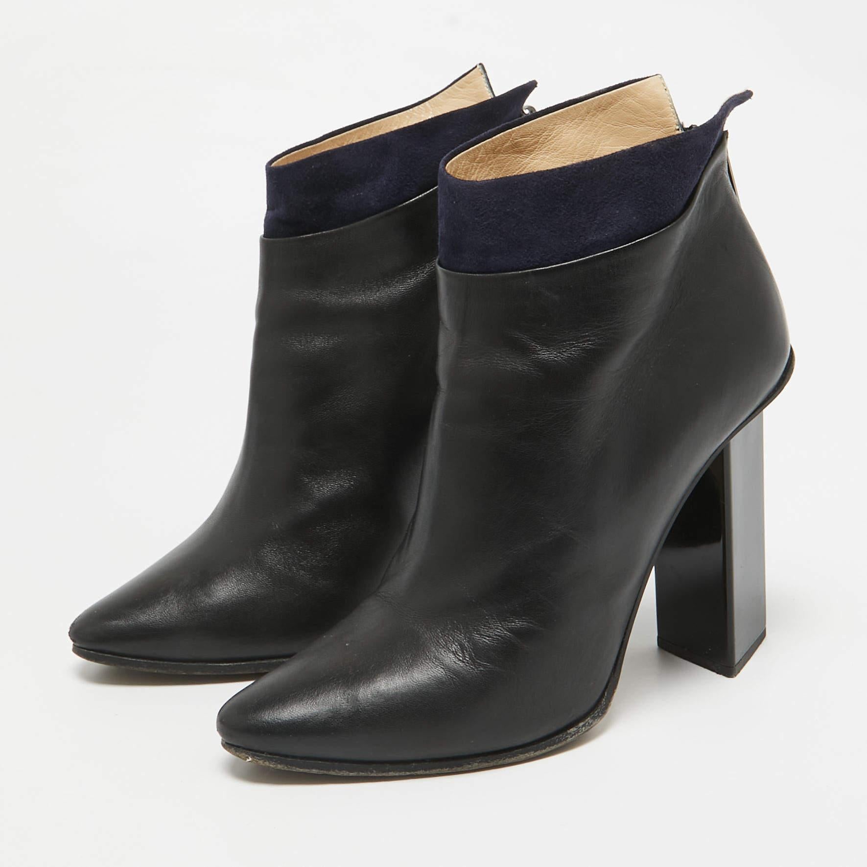 Adoptez un look sûr de vous avec ces bottines de créateur de Jimmy Choo. Elles sont en cuir et agrémentées de bordures en daim.  fermeture à glissière au dos  et des talons aiguilles.